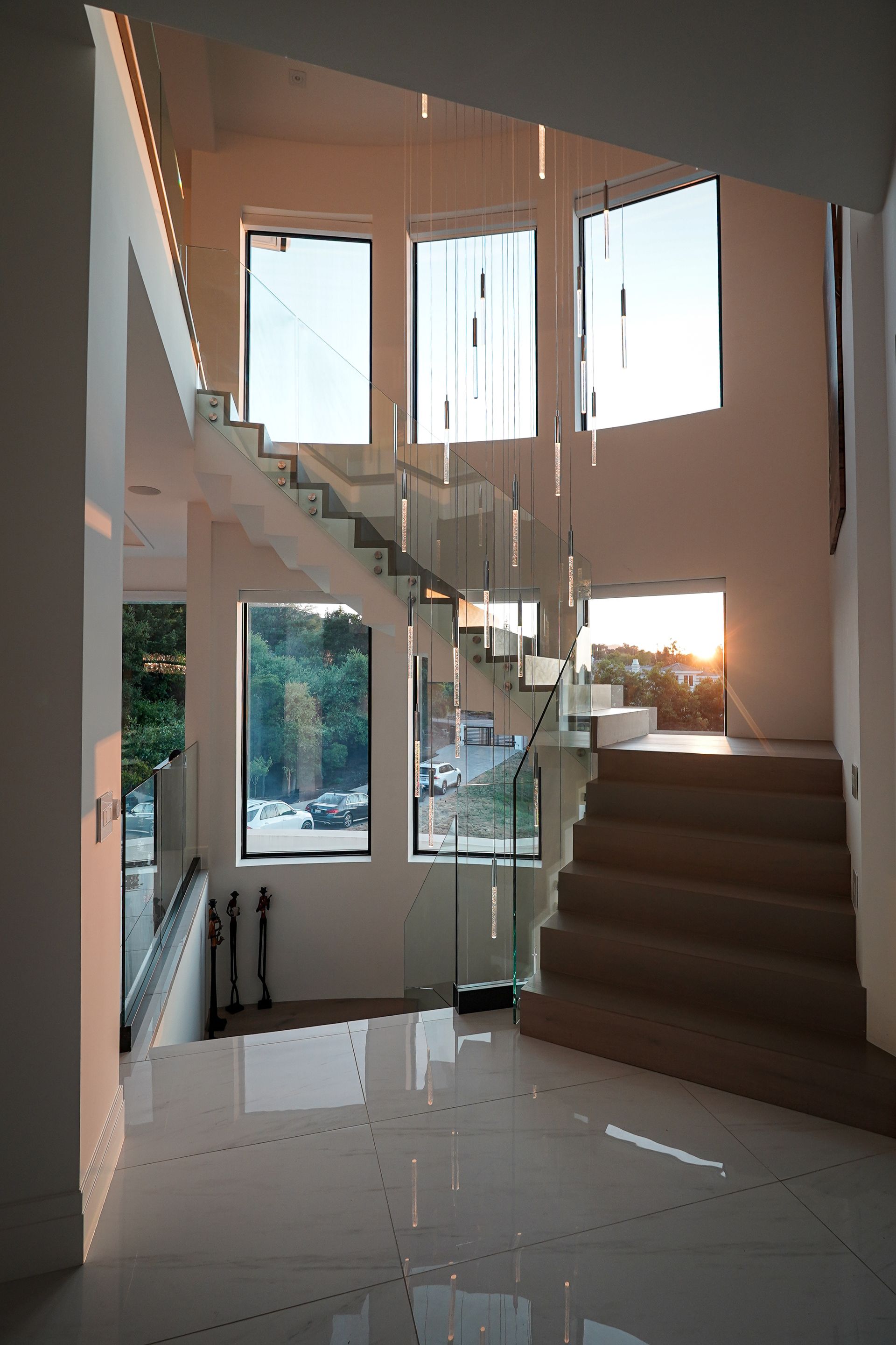 A staircase with a glass railing and a lot of windows