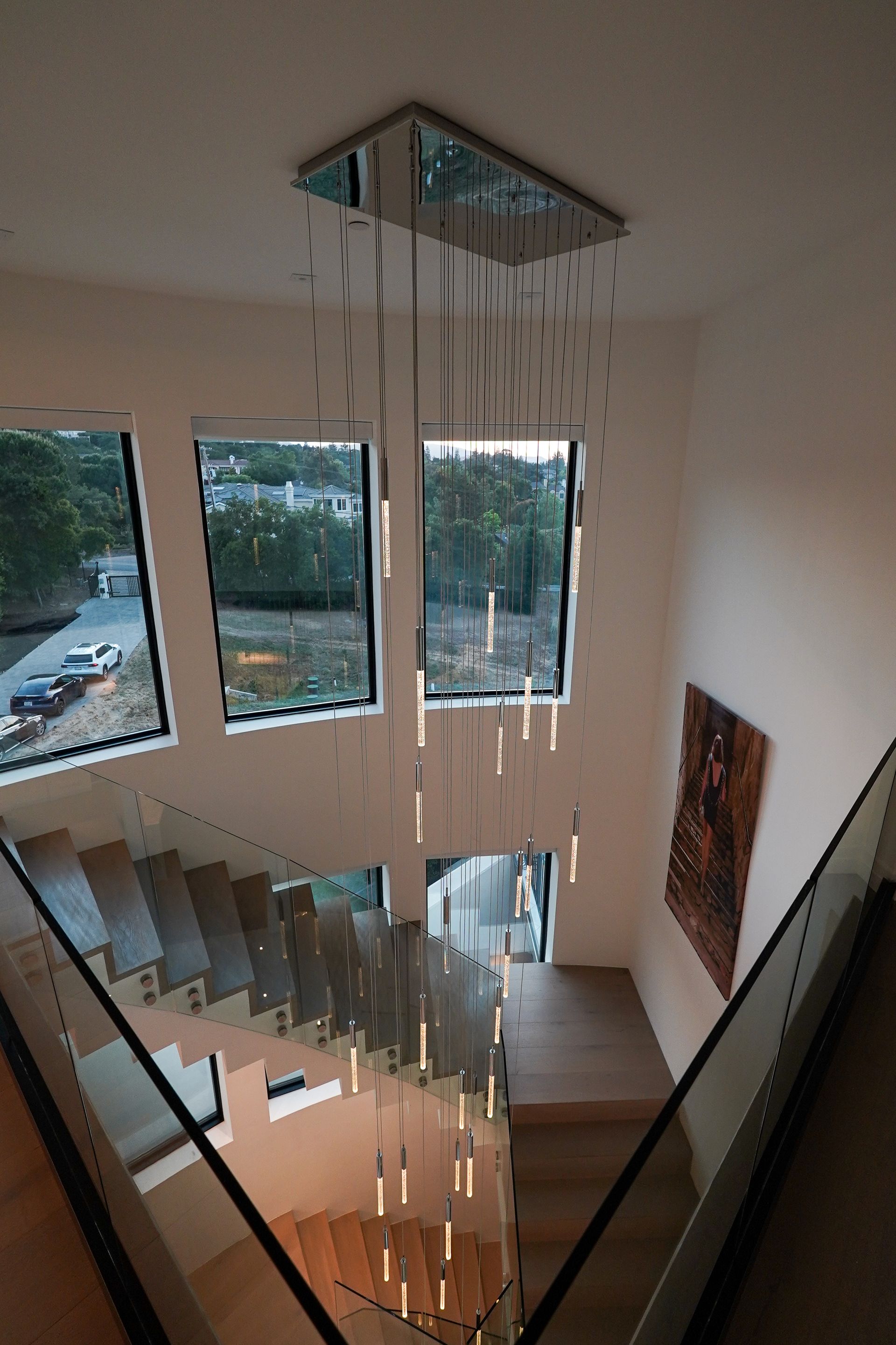 A staircase with a chandelier hanging from the ceiling