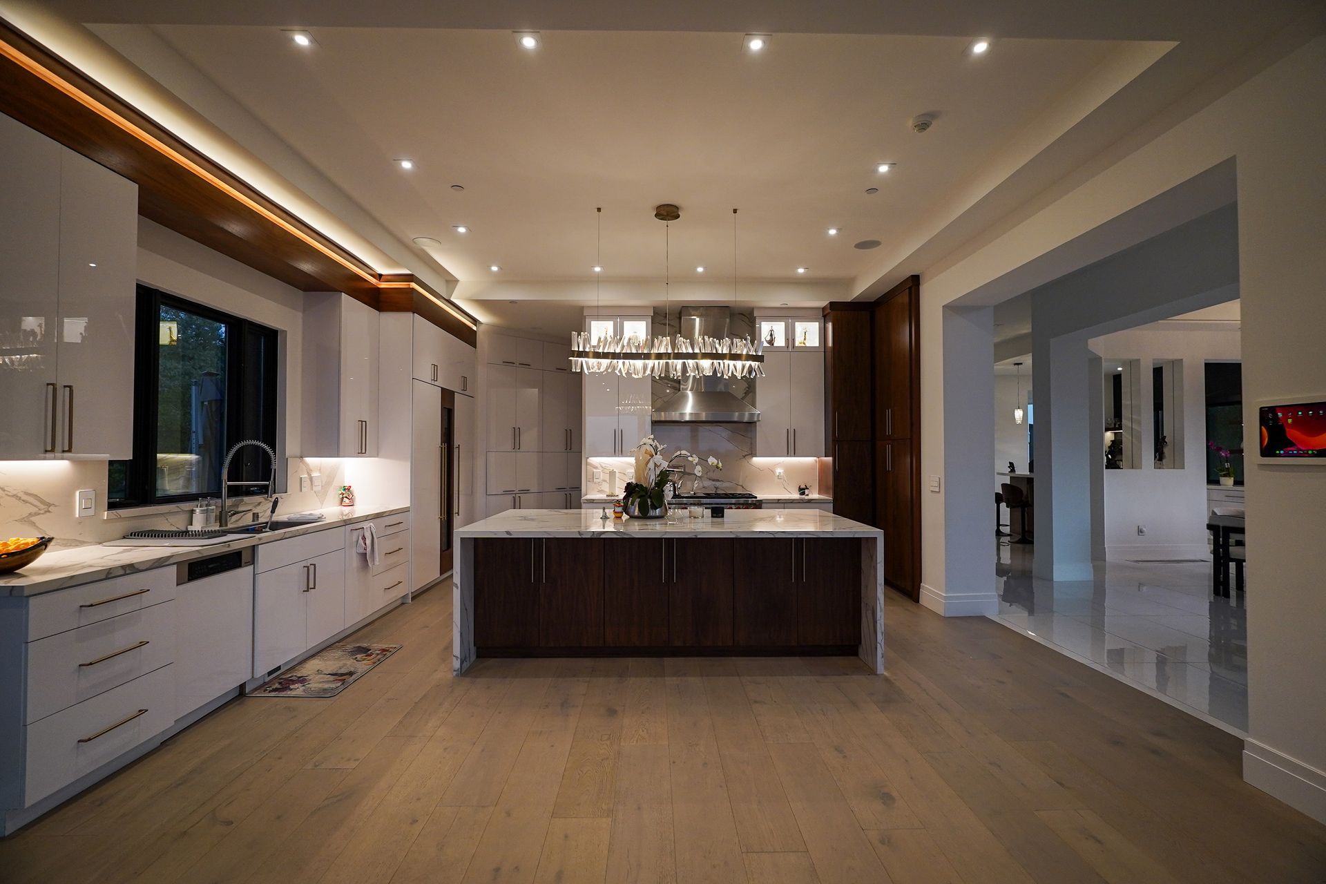 A large kitchen with white cabinets and a large island in the middle.
