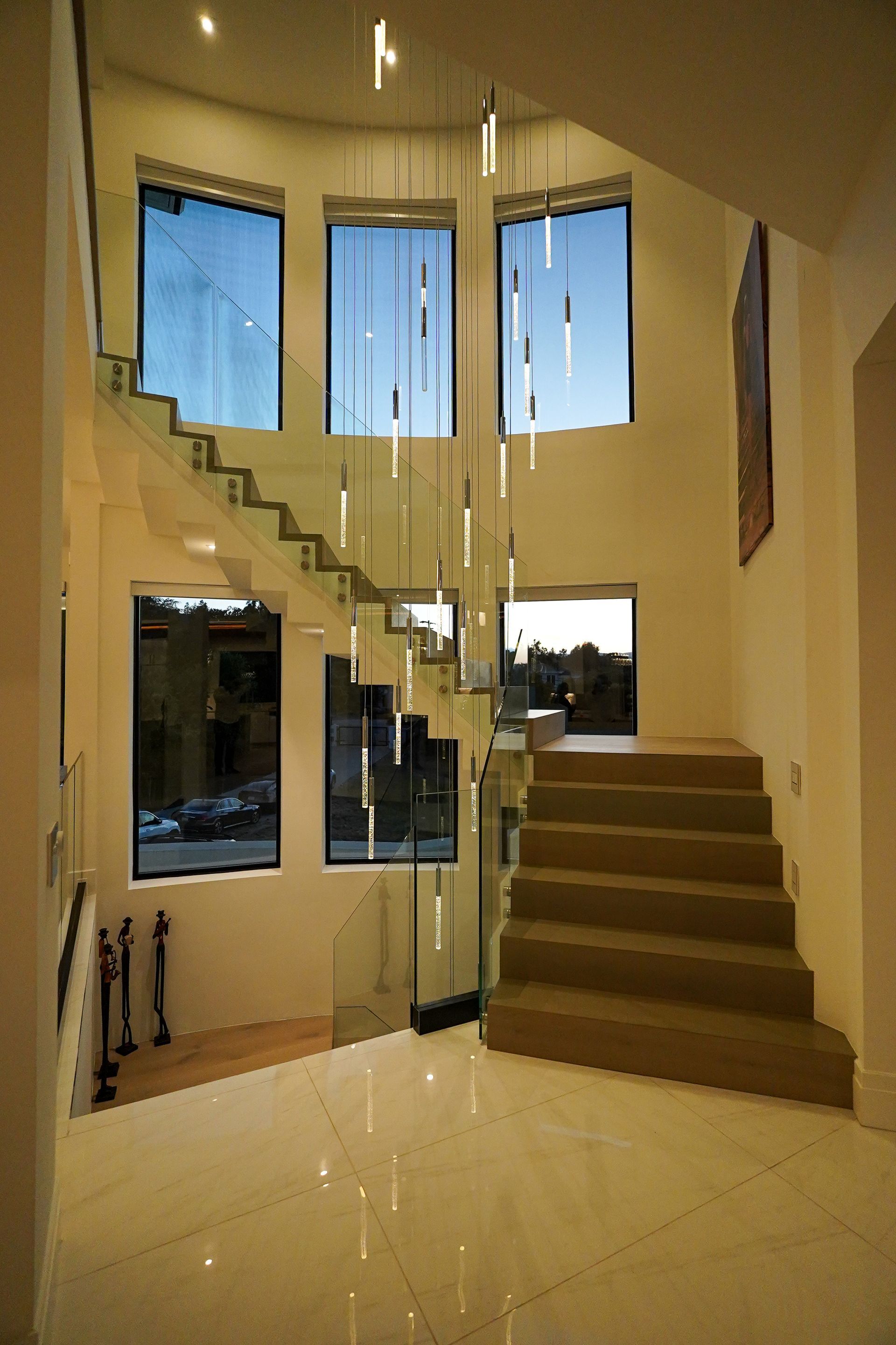 A staircase with a glass railing in a house