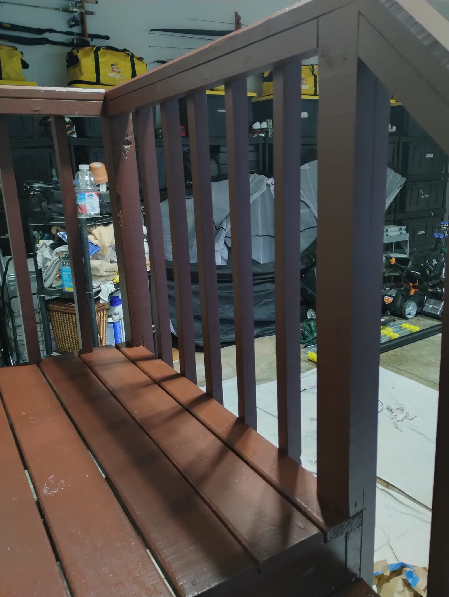 Wooden deck with railings painted brown.