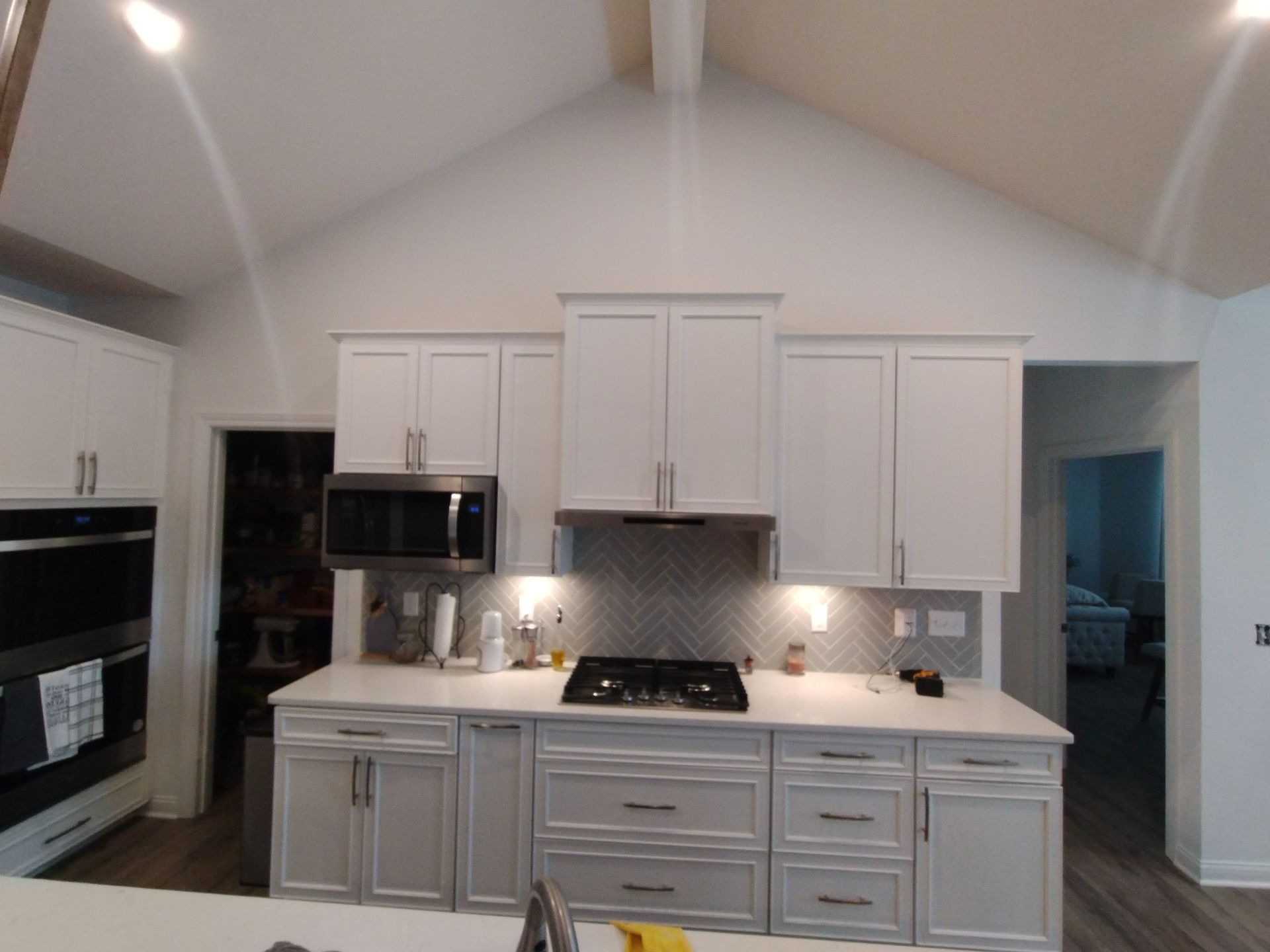 A large red house with a porch and a tree in front of it.