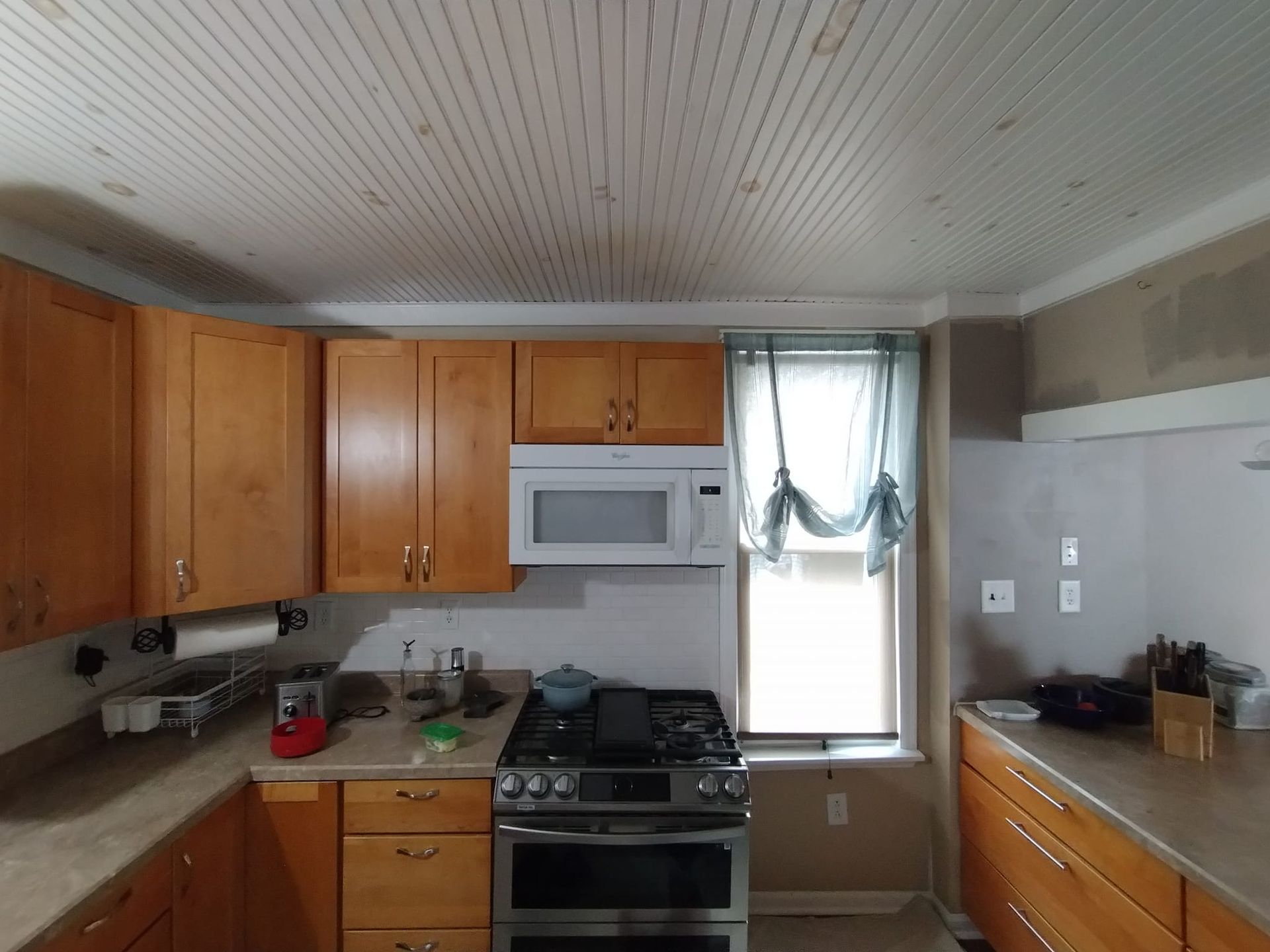 A kitchen with stainless steel appliances and wooden cabinets