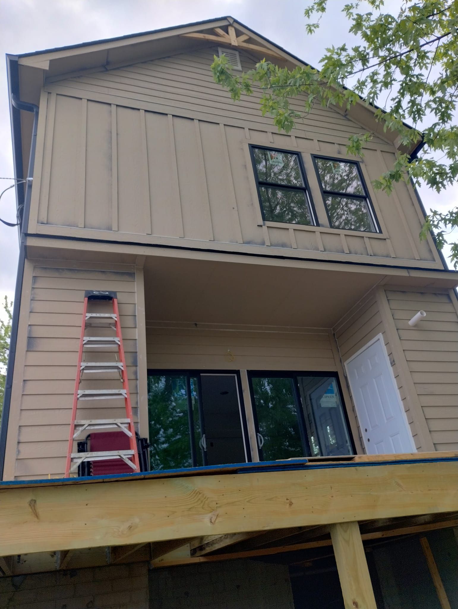 A house under construction with a ladder on the side of it.
