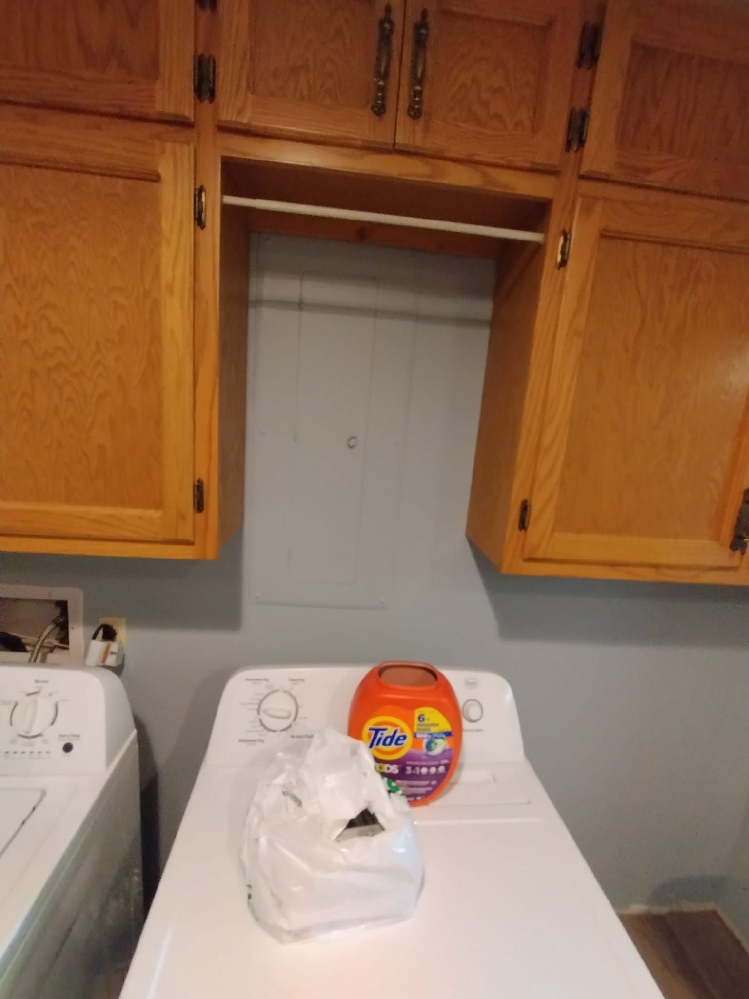 A bag of tide pods is sitting on top of a washing machine.