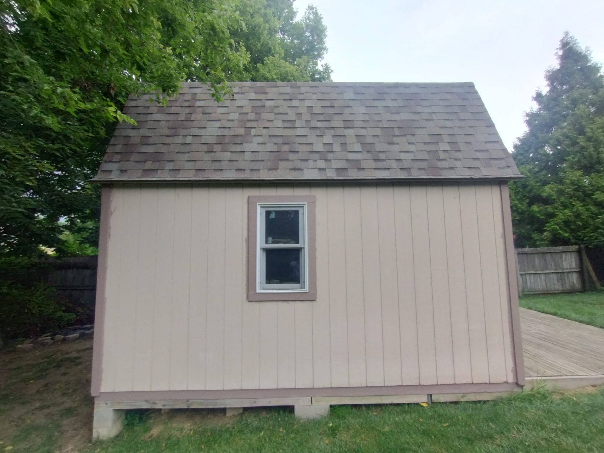 A shed with a window on the side of it