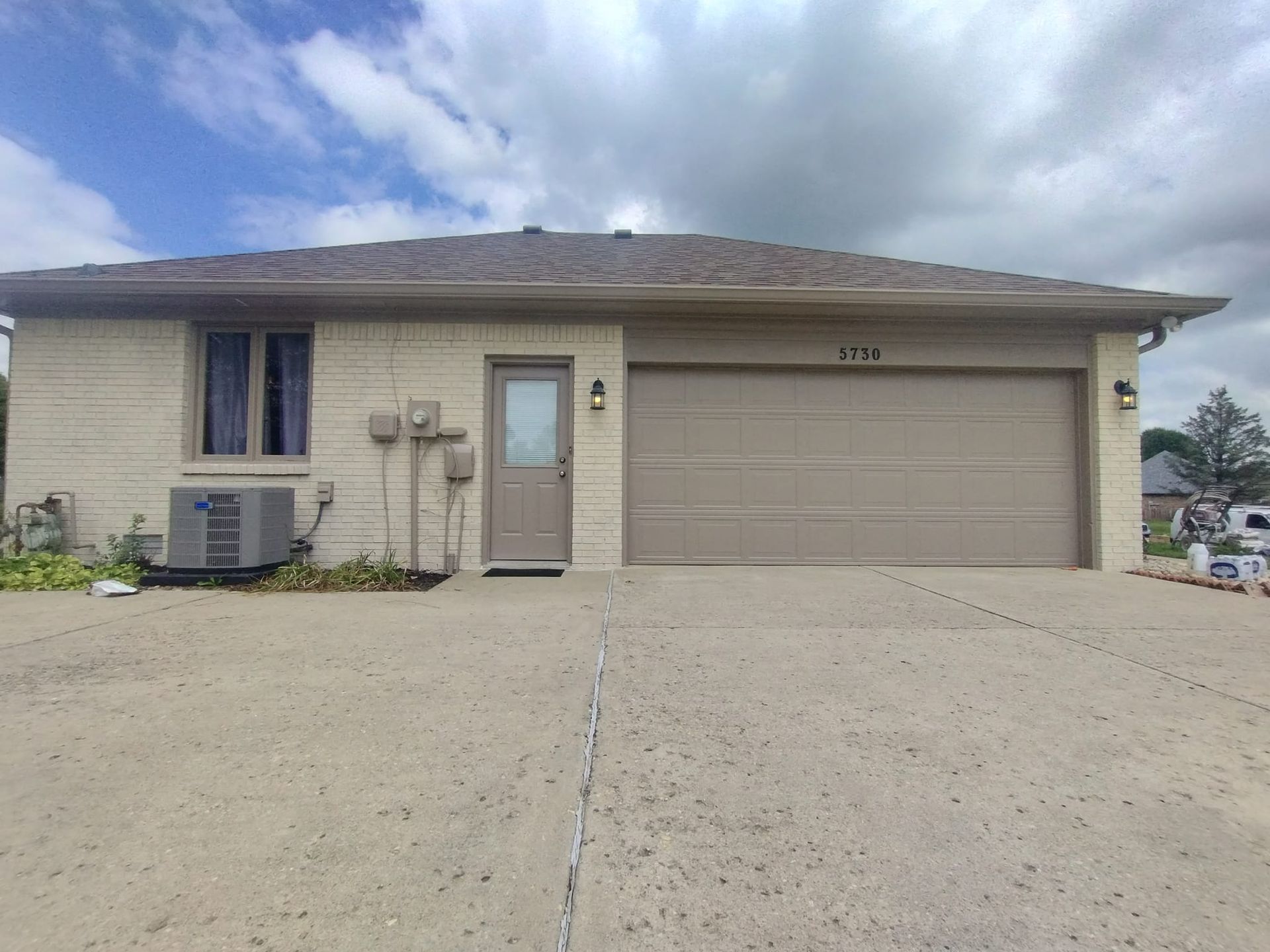 A house with a garage and a concrete driveway