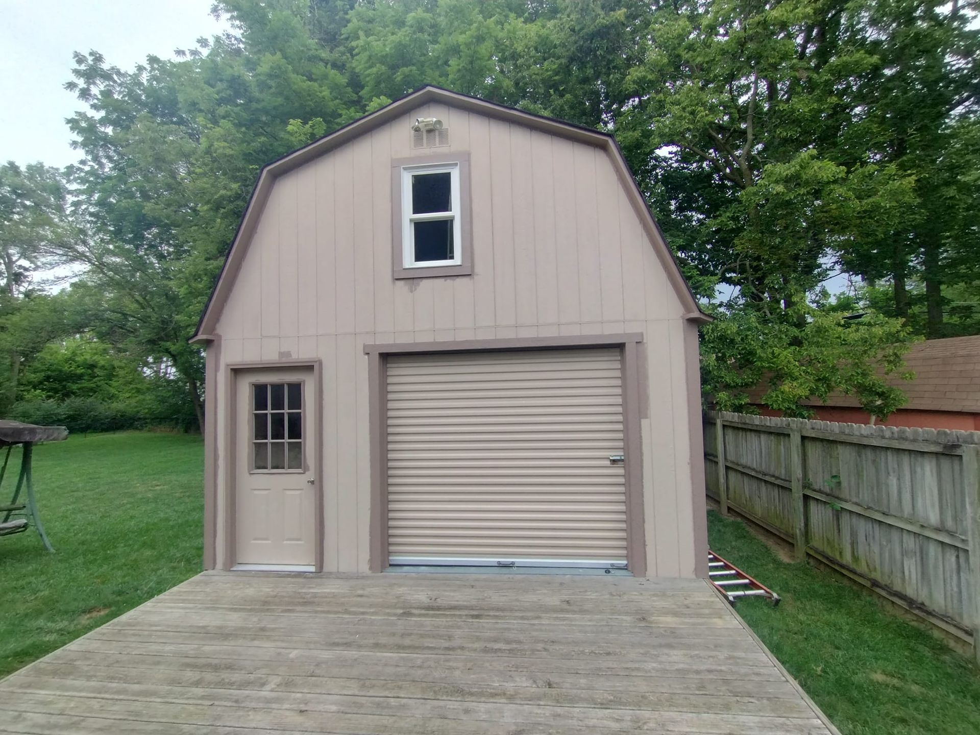 A barn with a garage door and a window