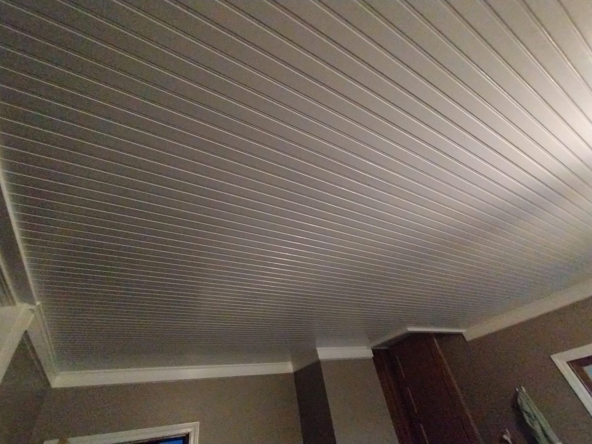 A room with a white ceiling and brown cabinets