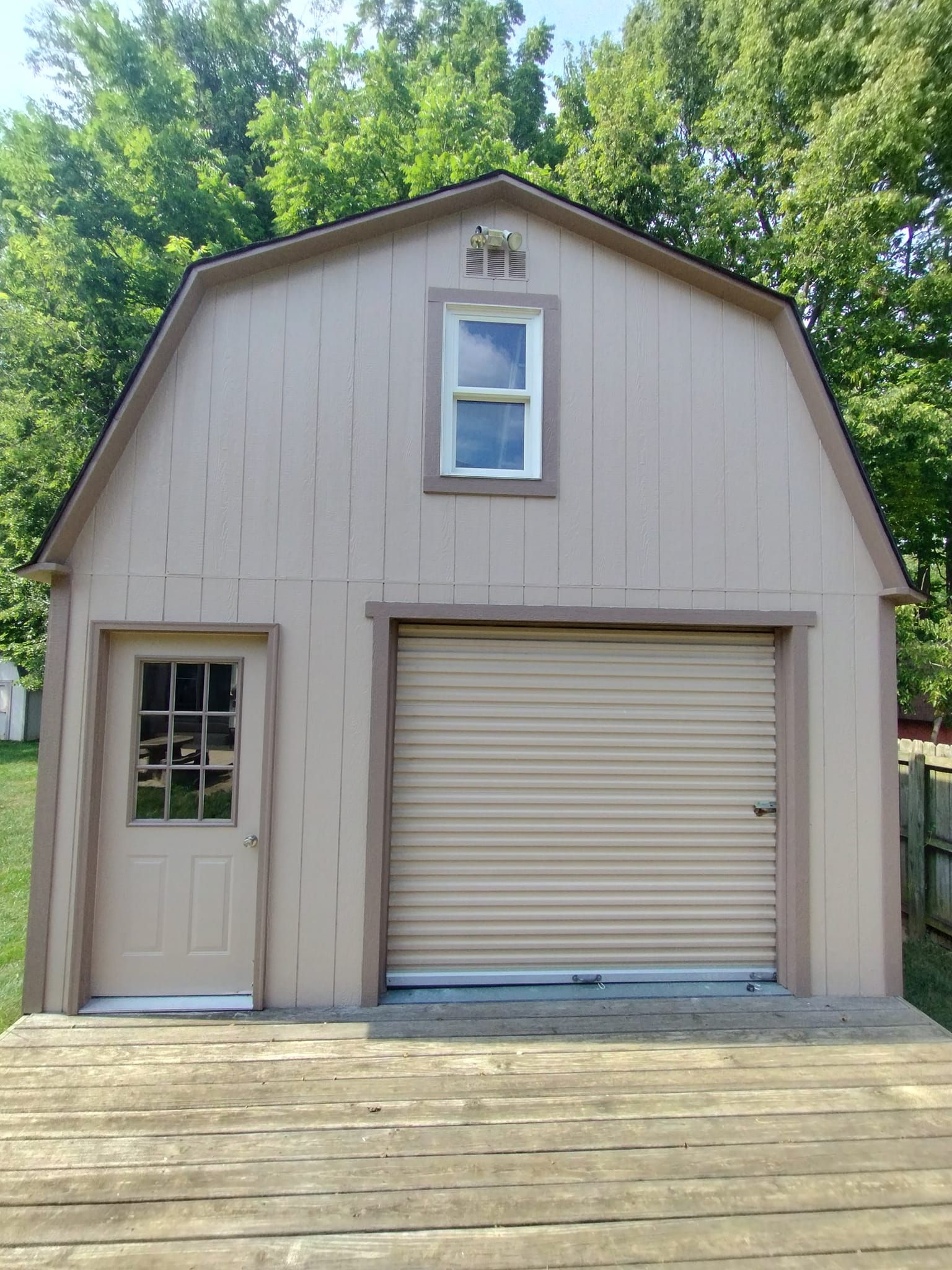 A barn with a garage door and a window
