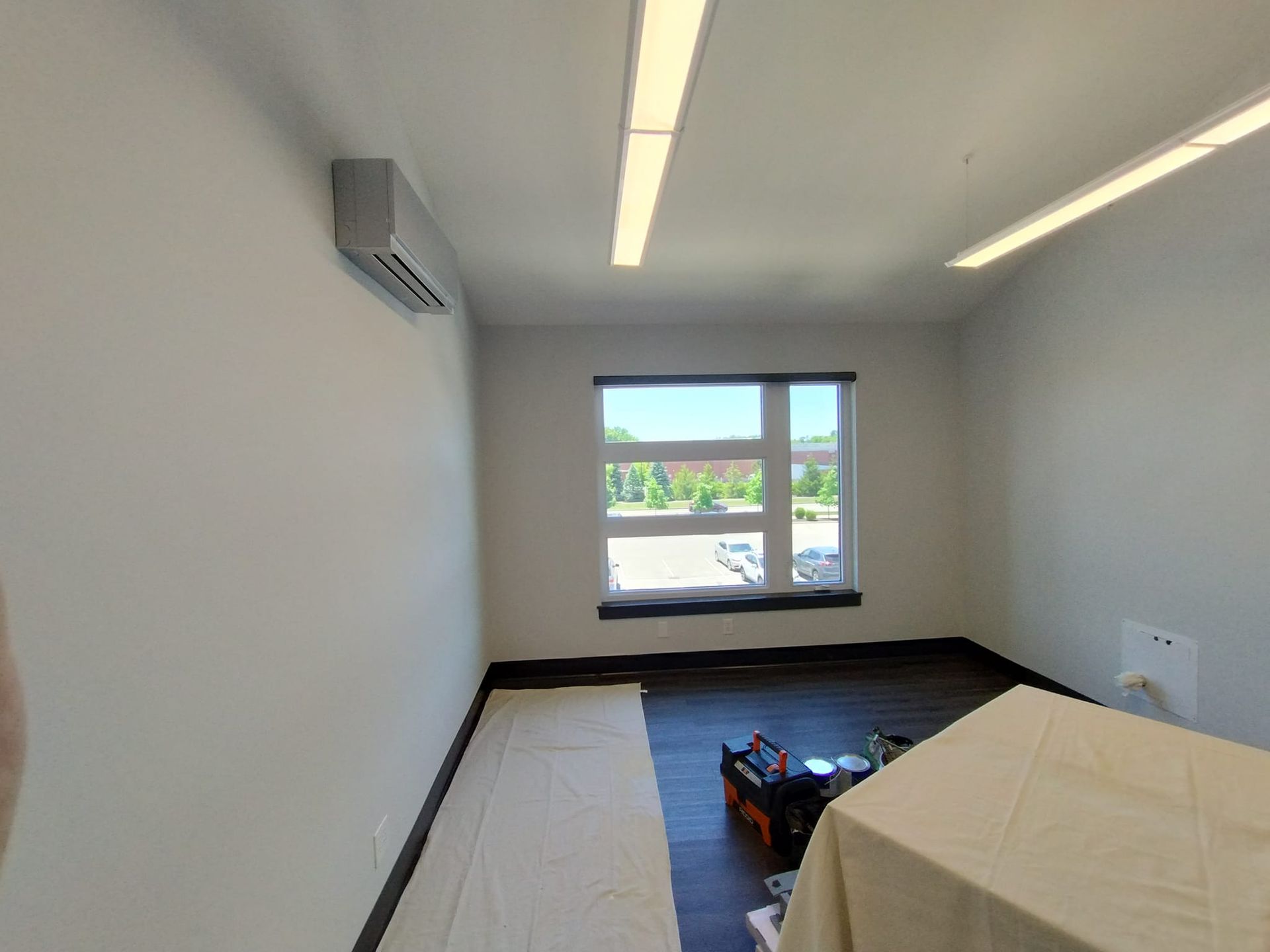 An empty room with a table and a window.