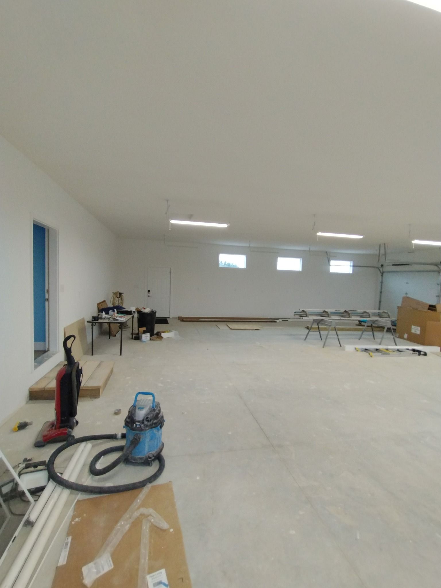 There is a vacuum cleaner in the middle of the room.