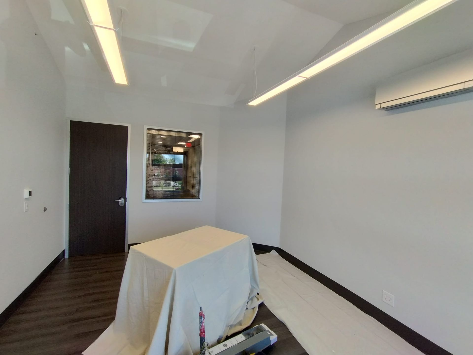 An empty room with a table and a window.