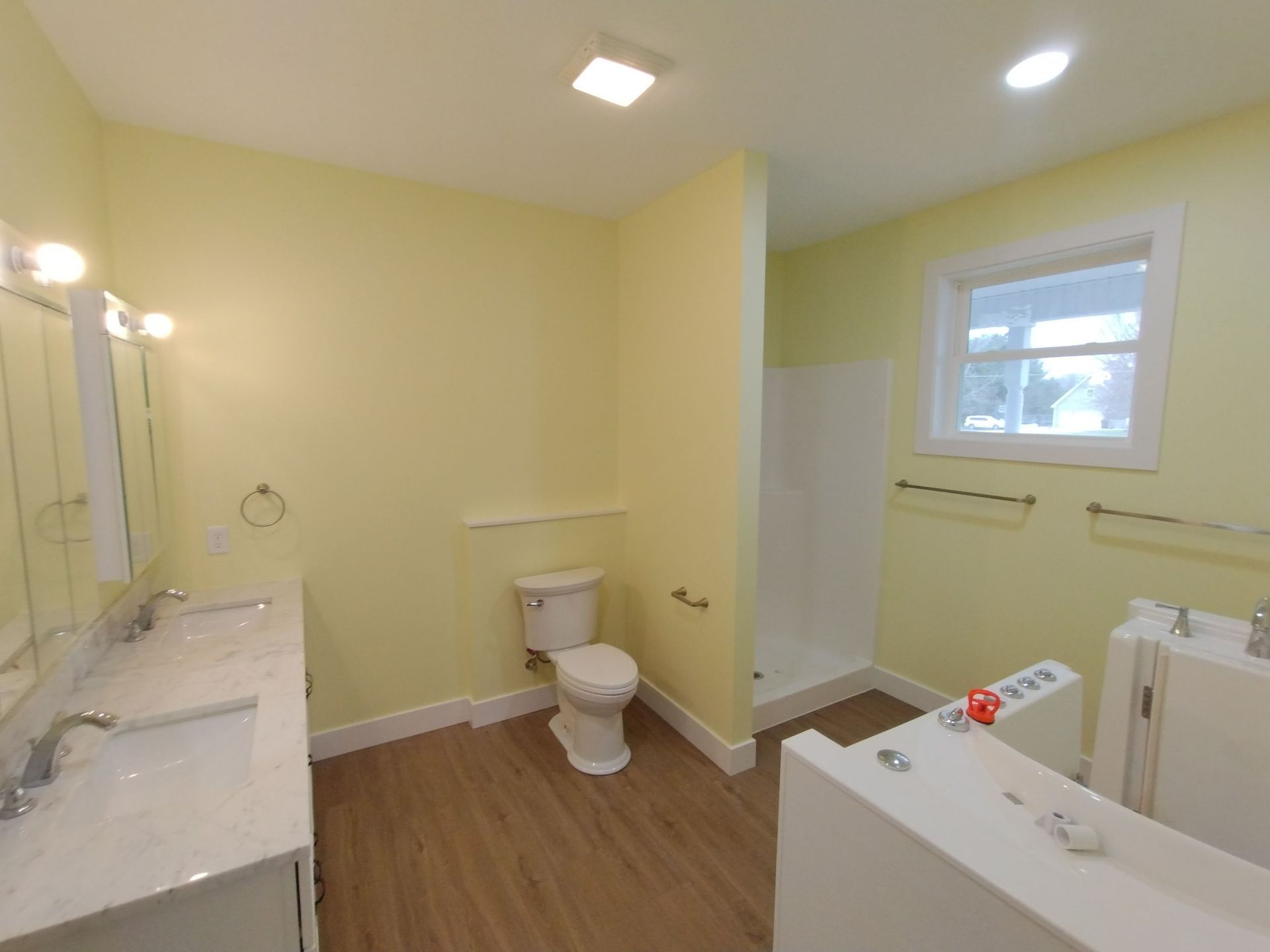 A bathroom with a toilet , sink , and bathtub.