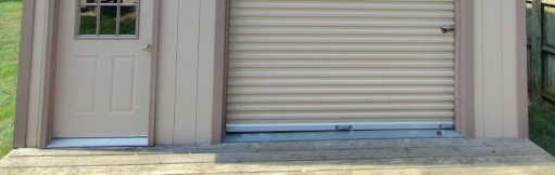 A small shed with a door and a garage door.
