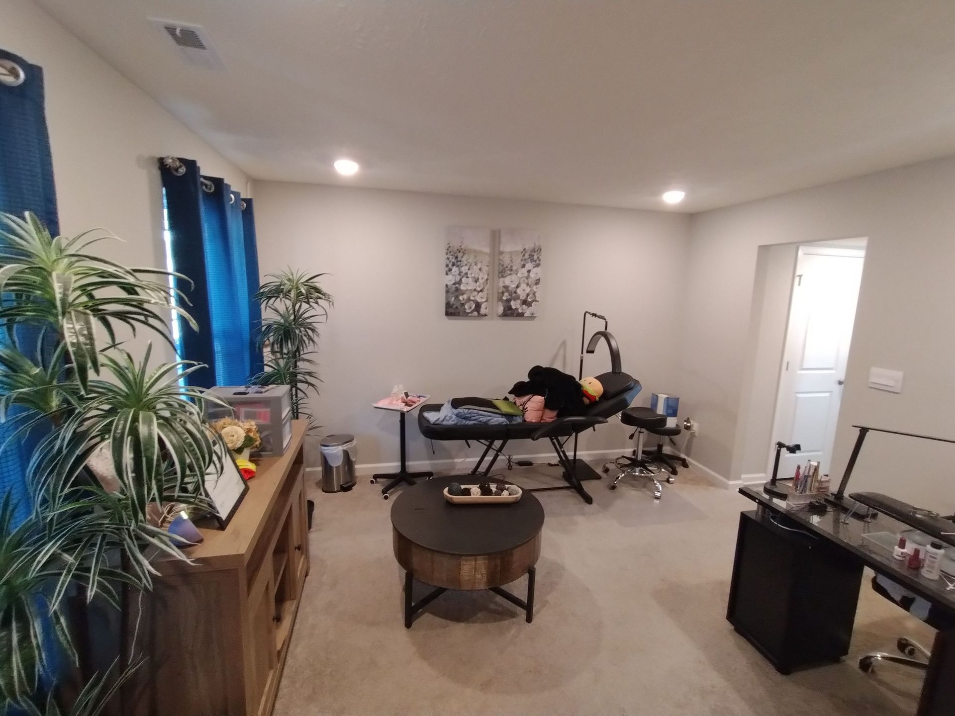 A living room with a table , chairs , and a coffee table.