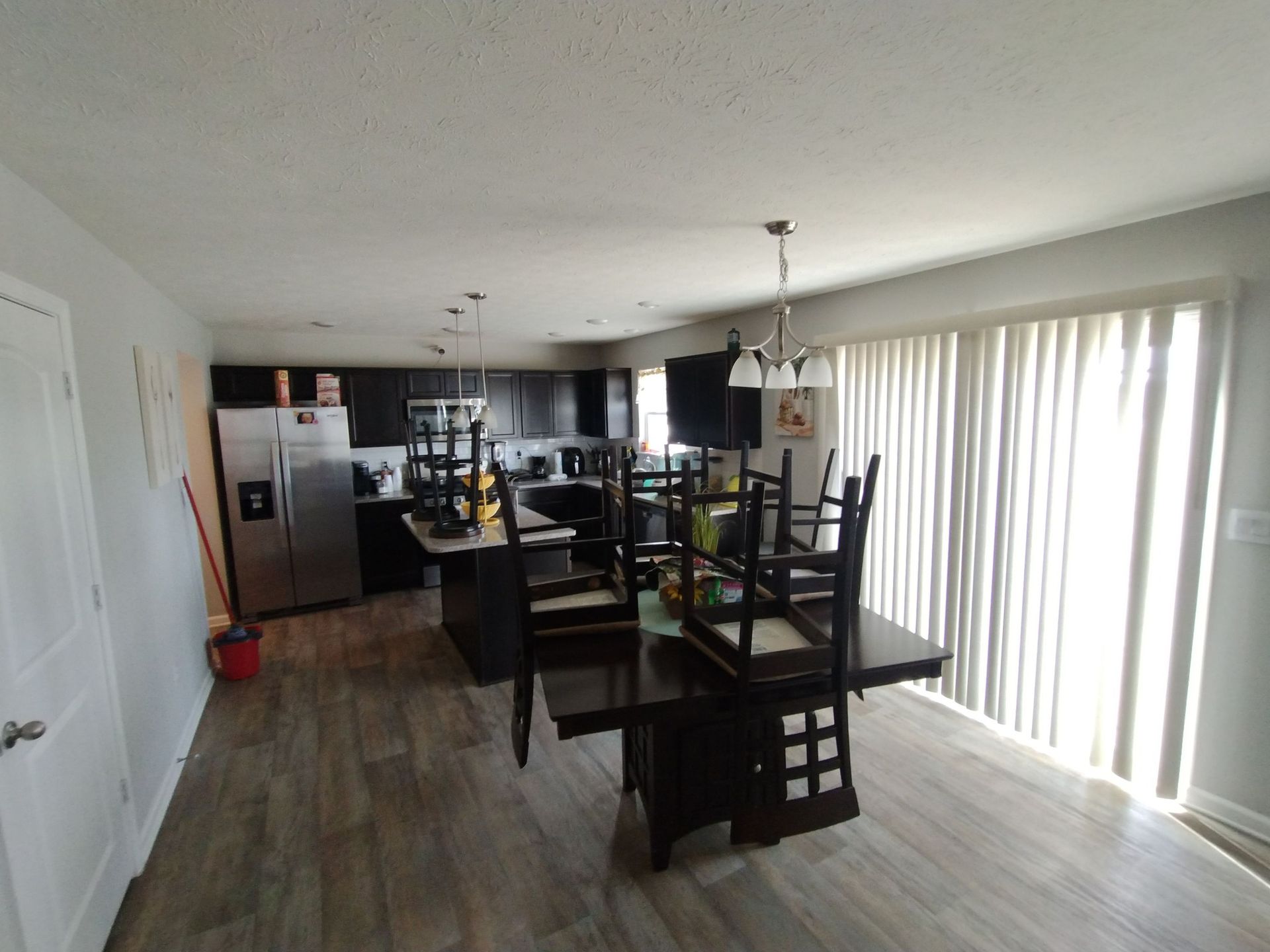 A kitchen with a table and chairs in it