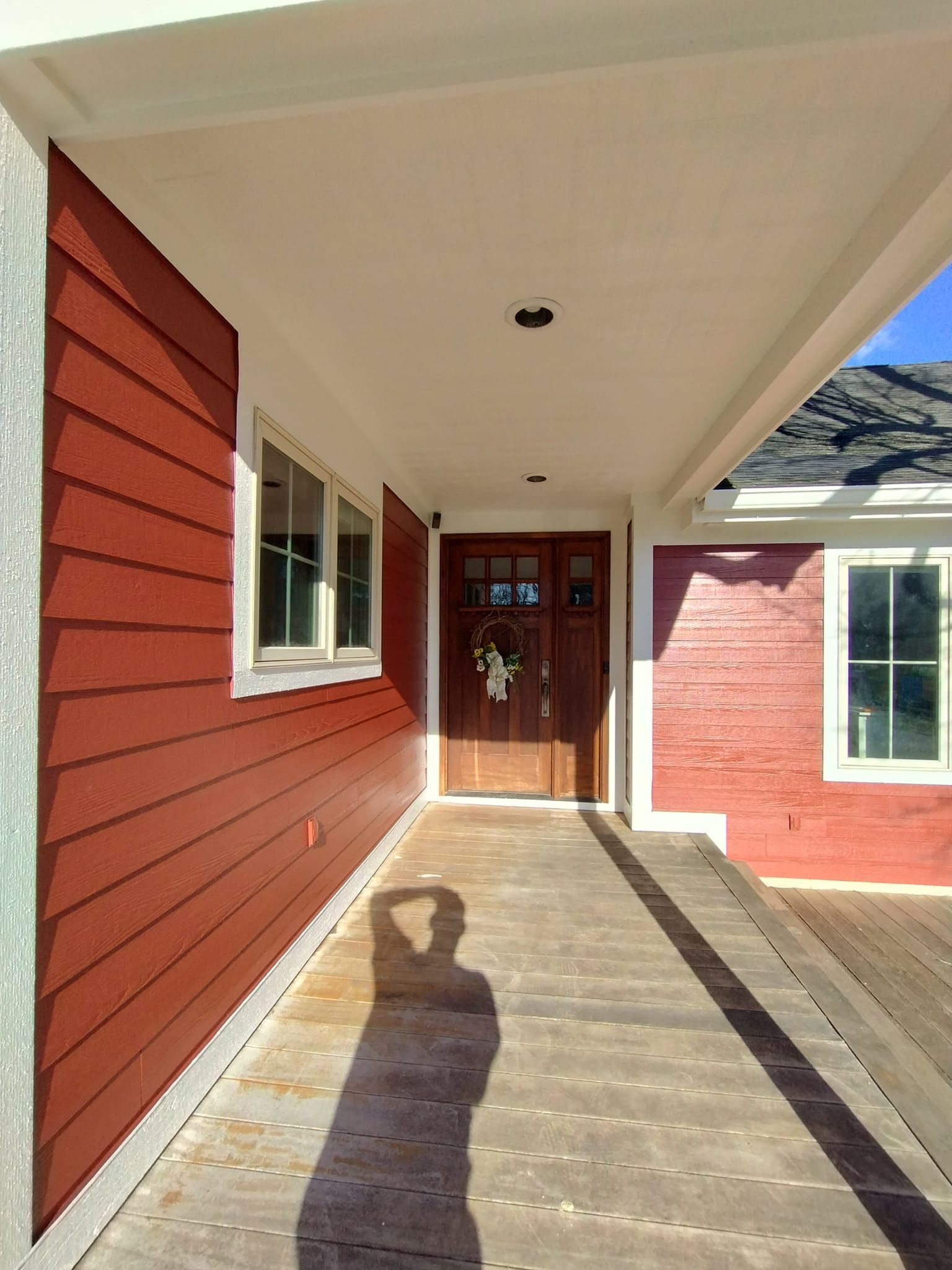 A red house with a porch and a wooden door