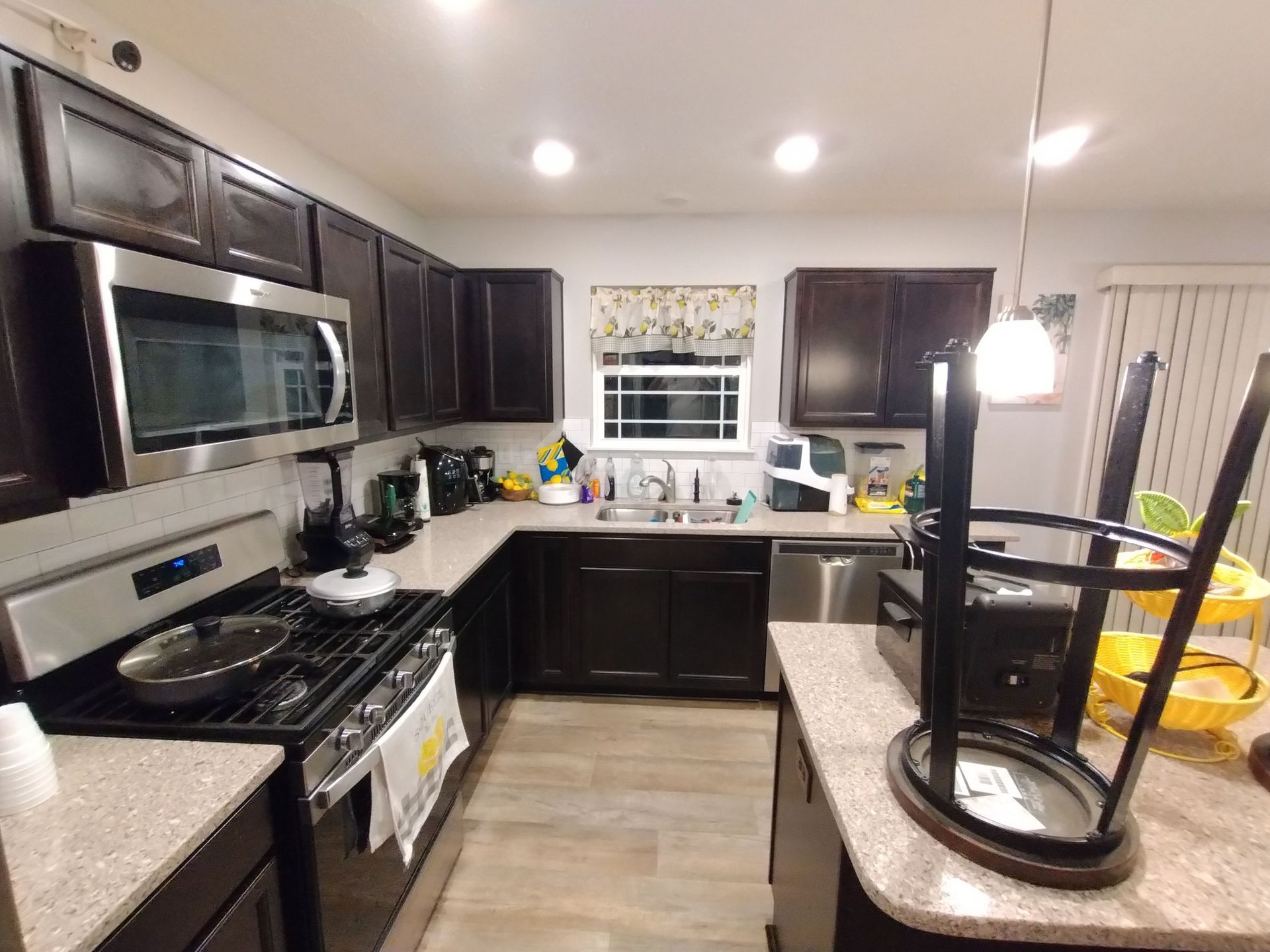 A kitchen with black cabinets and stainless steel appliances
