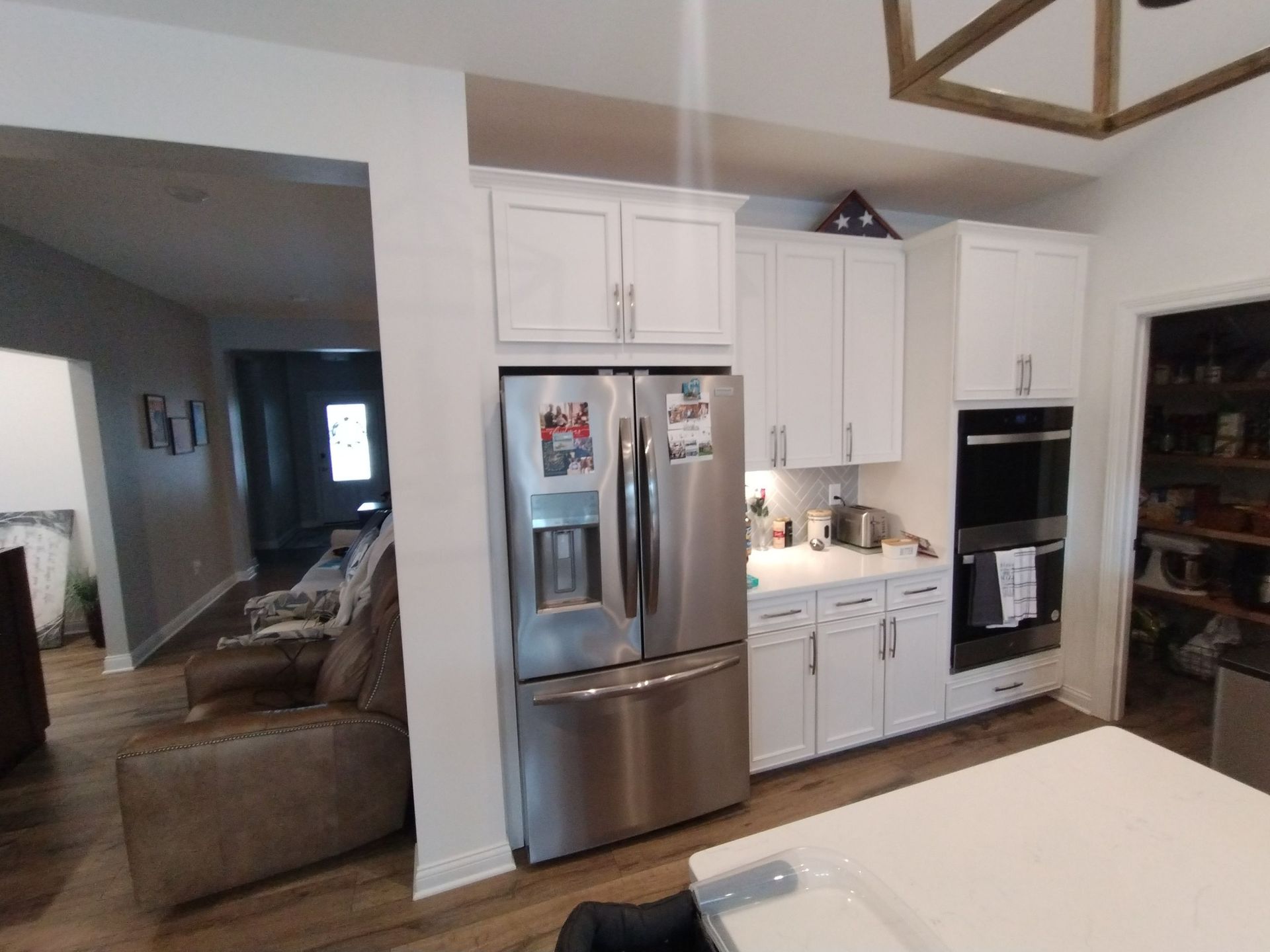 A kitchen with stainless steel appliances and white cabinets.