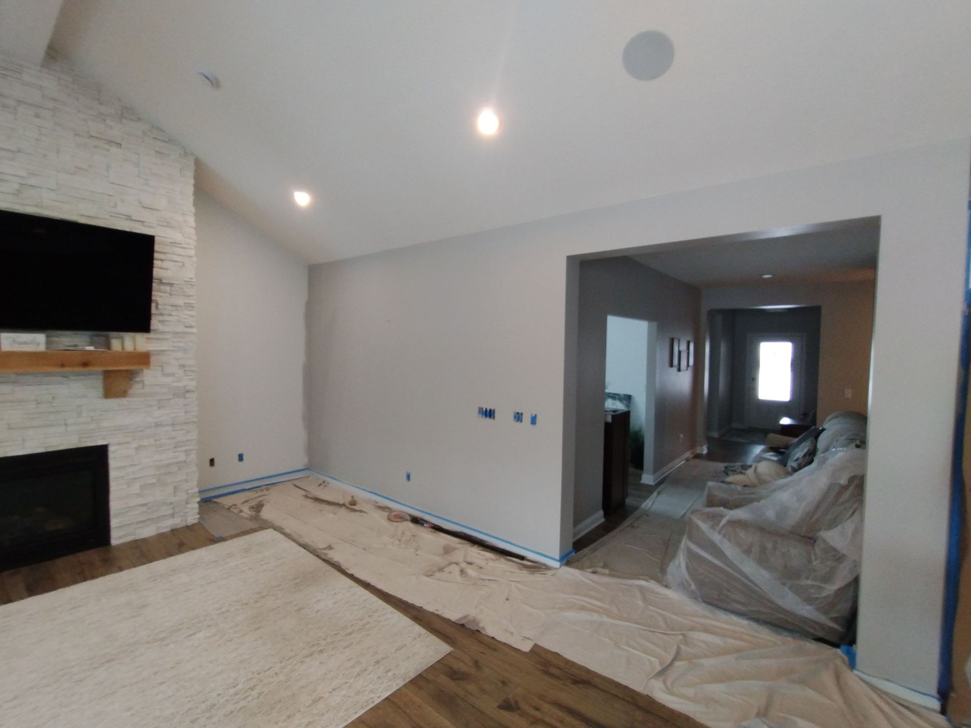 A living room with a fireplace and a flat screen tv.