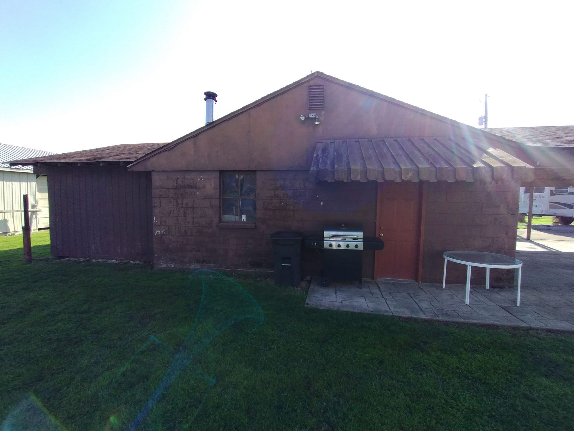 A small brick house with a canopy over the door