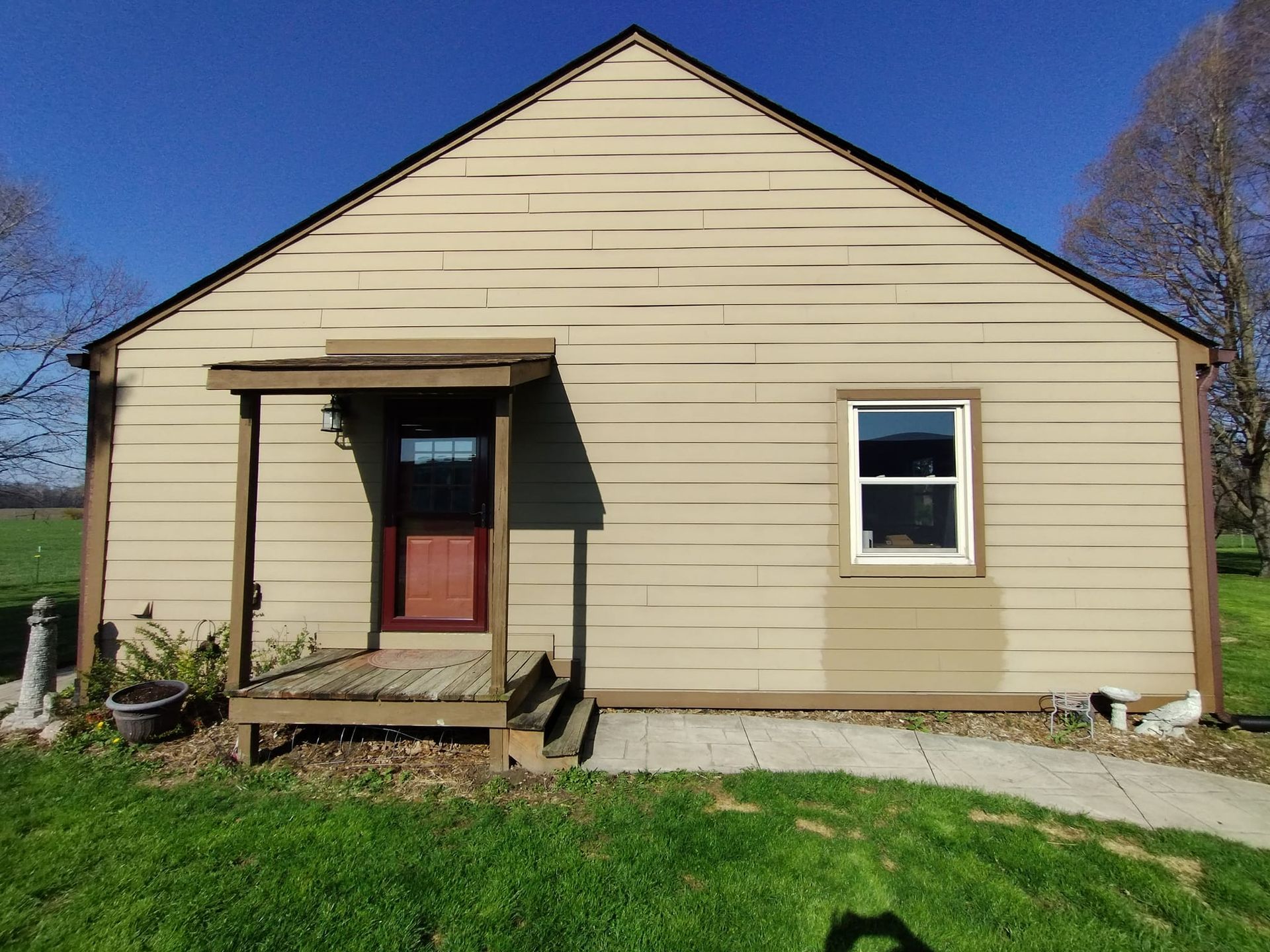 A small house with a porch and a window