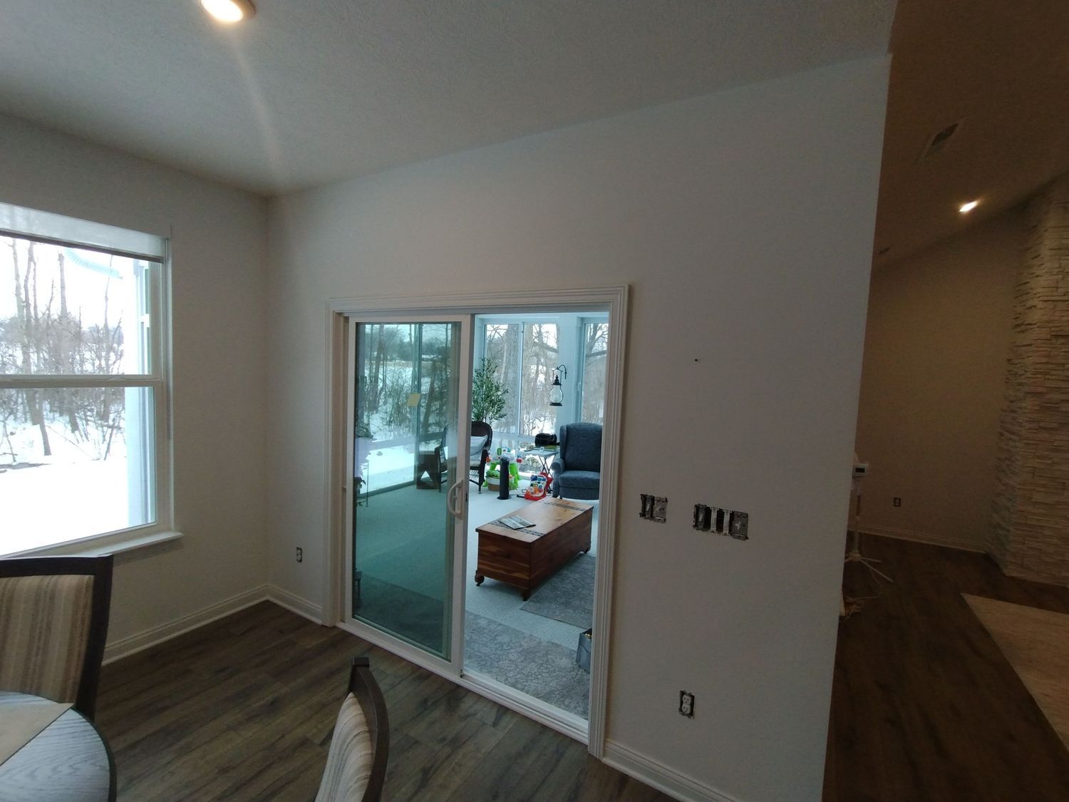A living room with sliding glass doors leading to a patio.