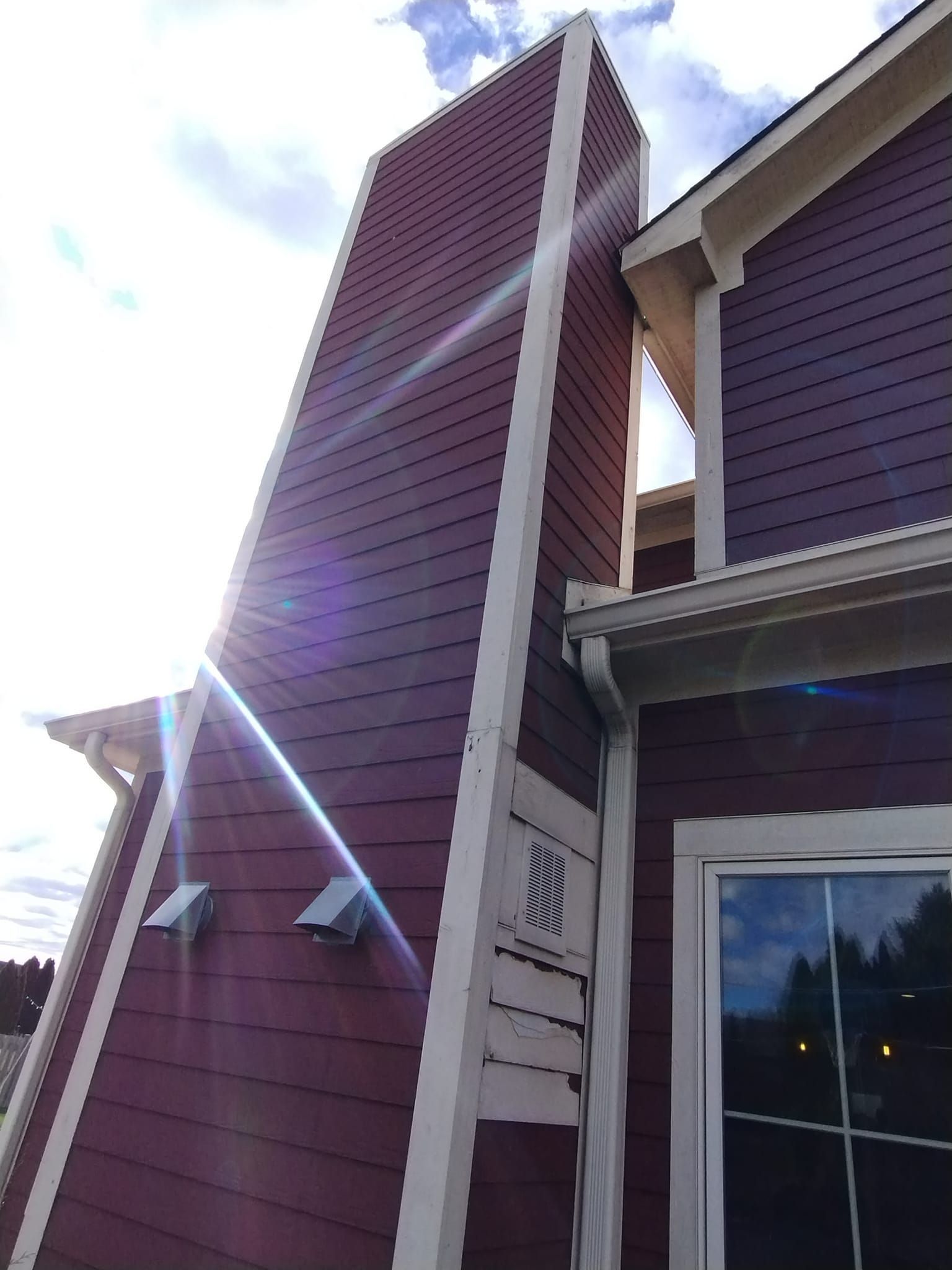 A purple house with a chimney on the side of it