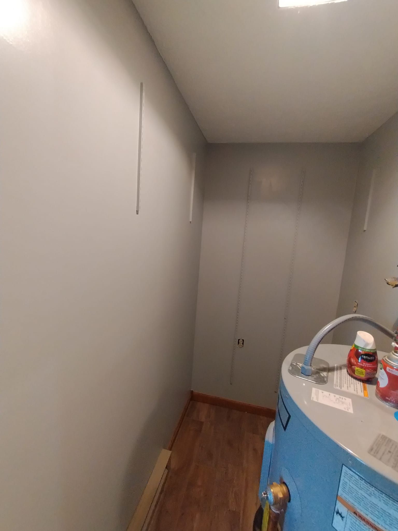 A bathroom with a water heater and a sink.