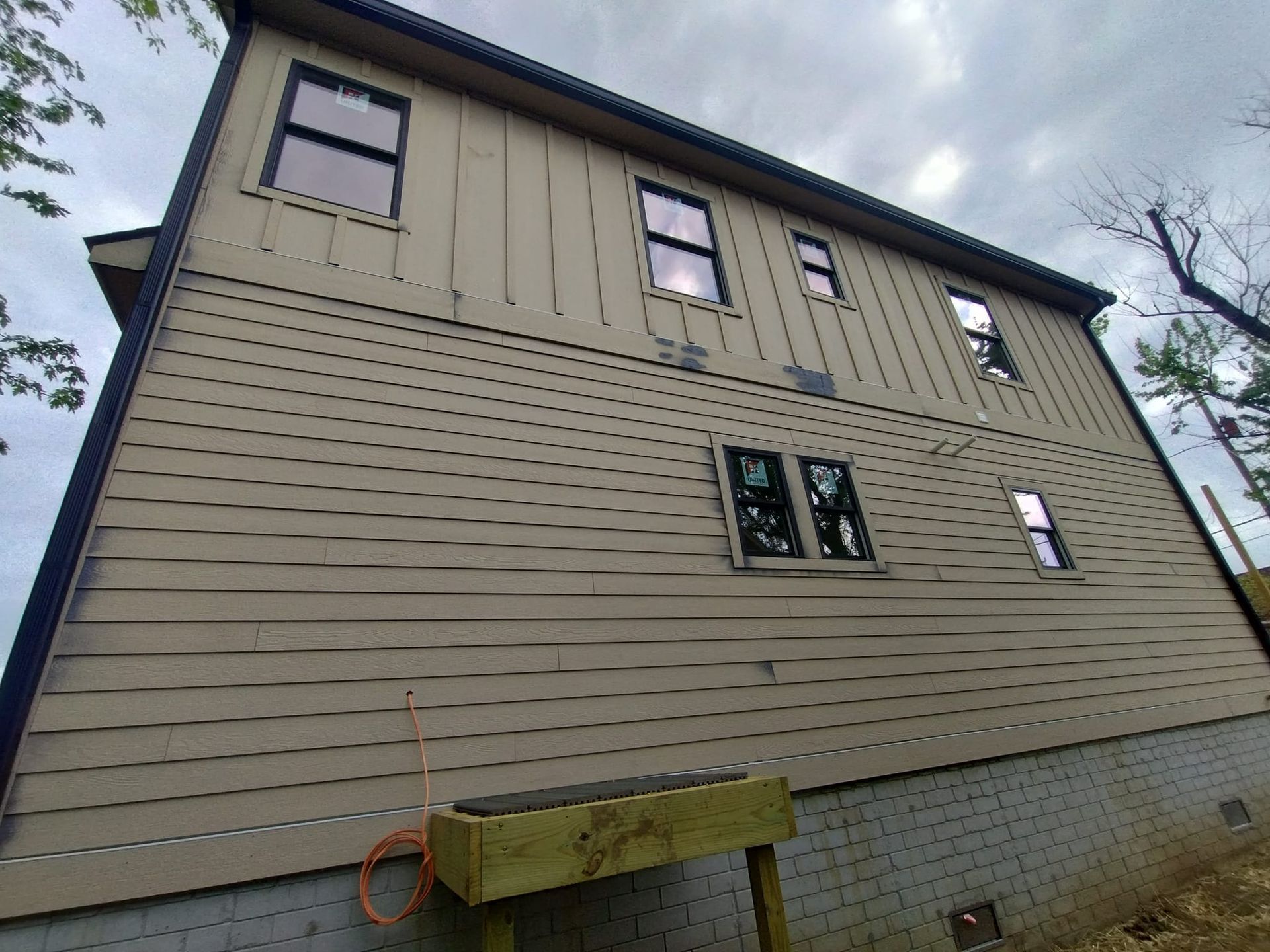 A large house with a lot of windows is being built.
