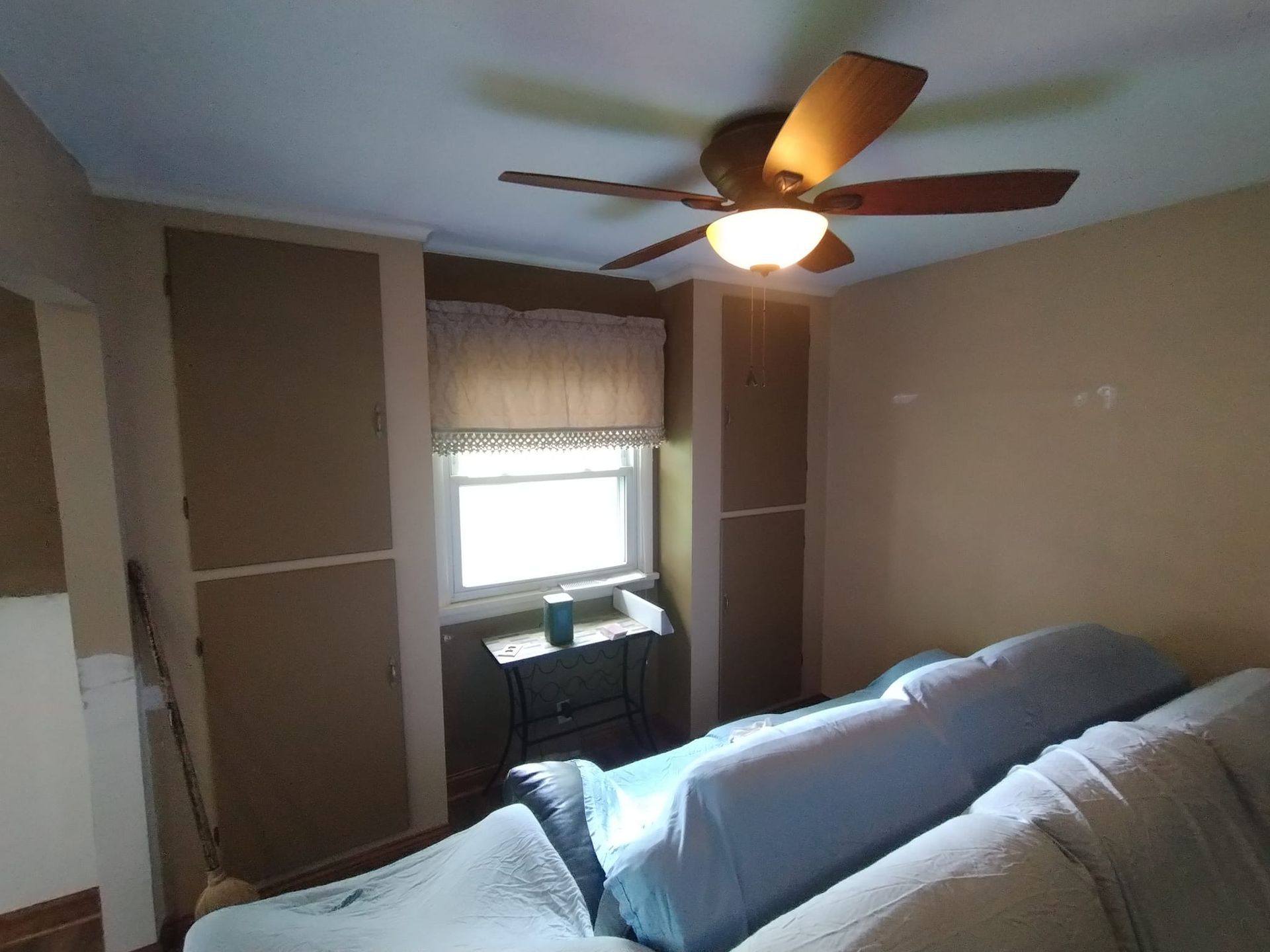 A living room with a ceiling fan and a couch.