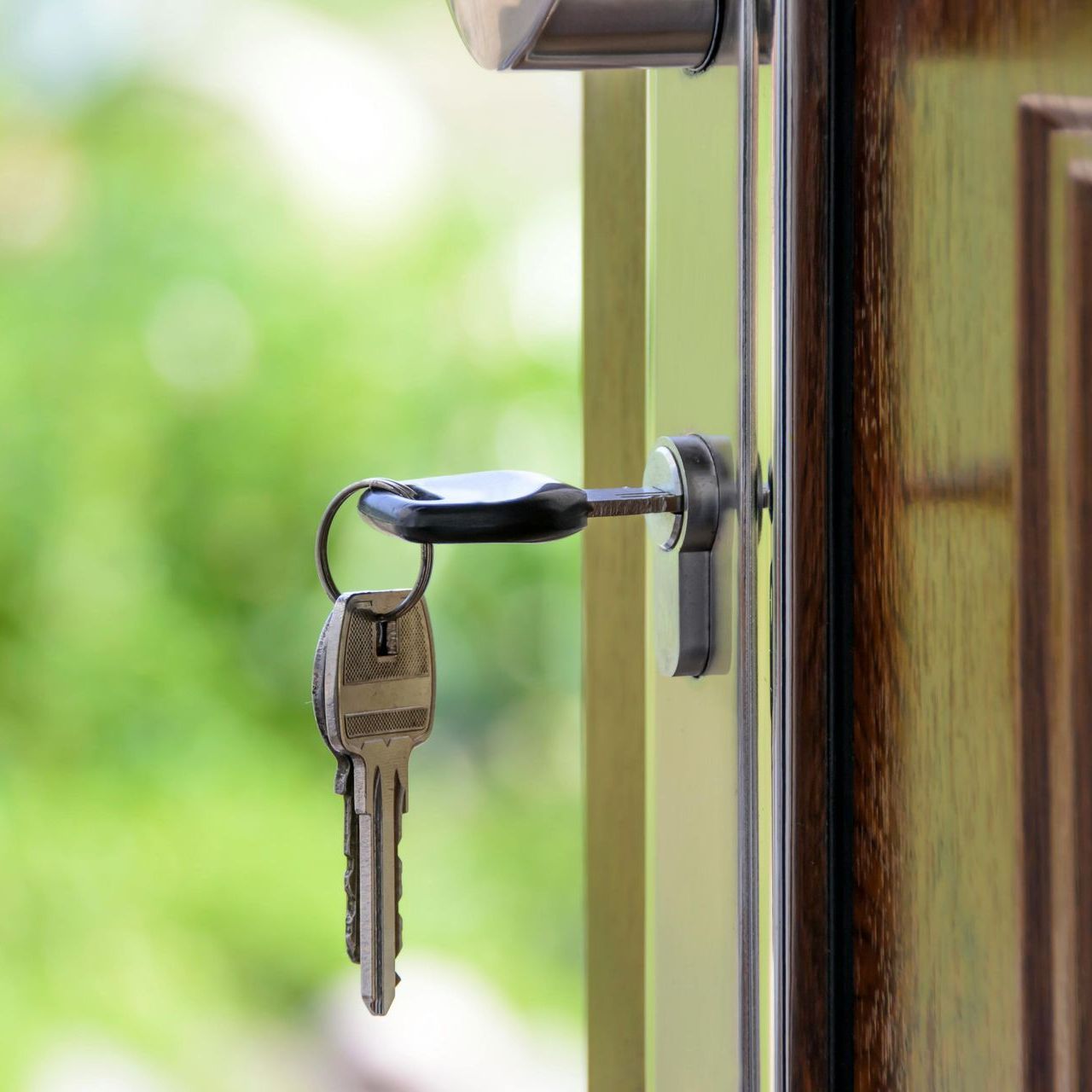 A close up of a door with two keys in it