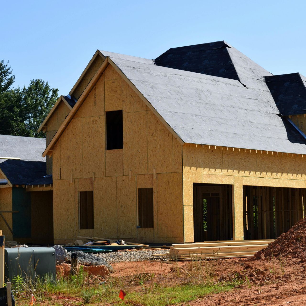A house that is being built with a gray roof