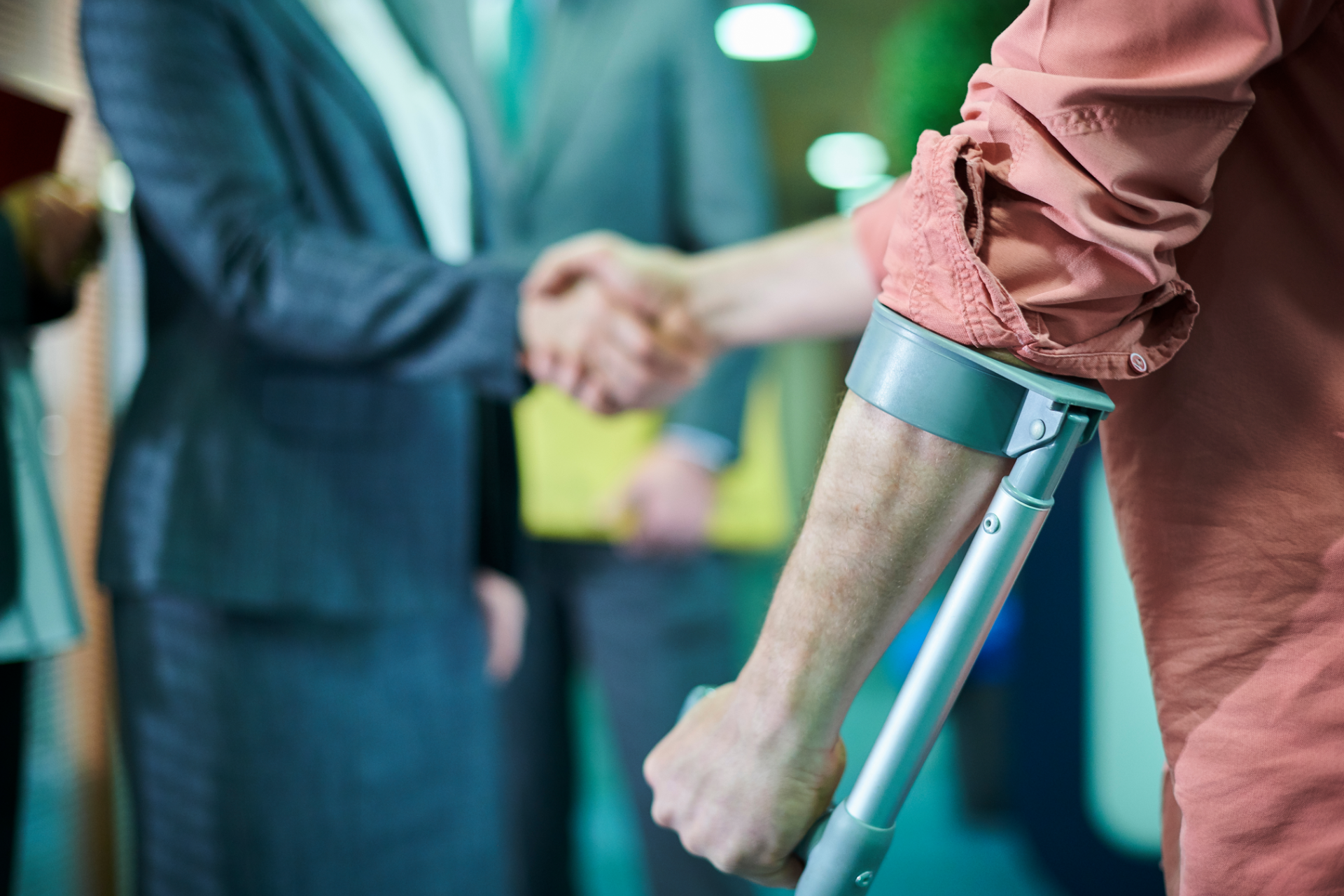Elderly couple smiles while looking at a laptop on a couch. Woman has arm around man.
