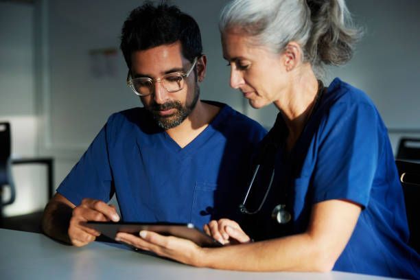A man and a woman are looking at a tablet together.