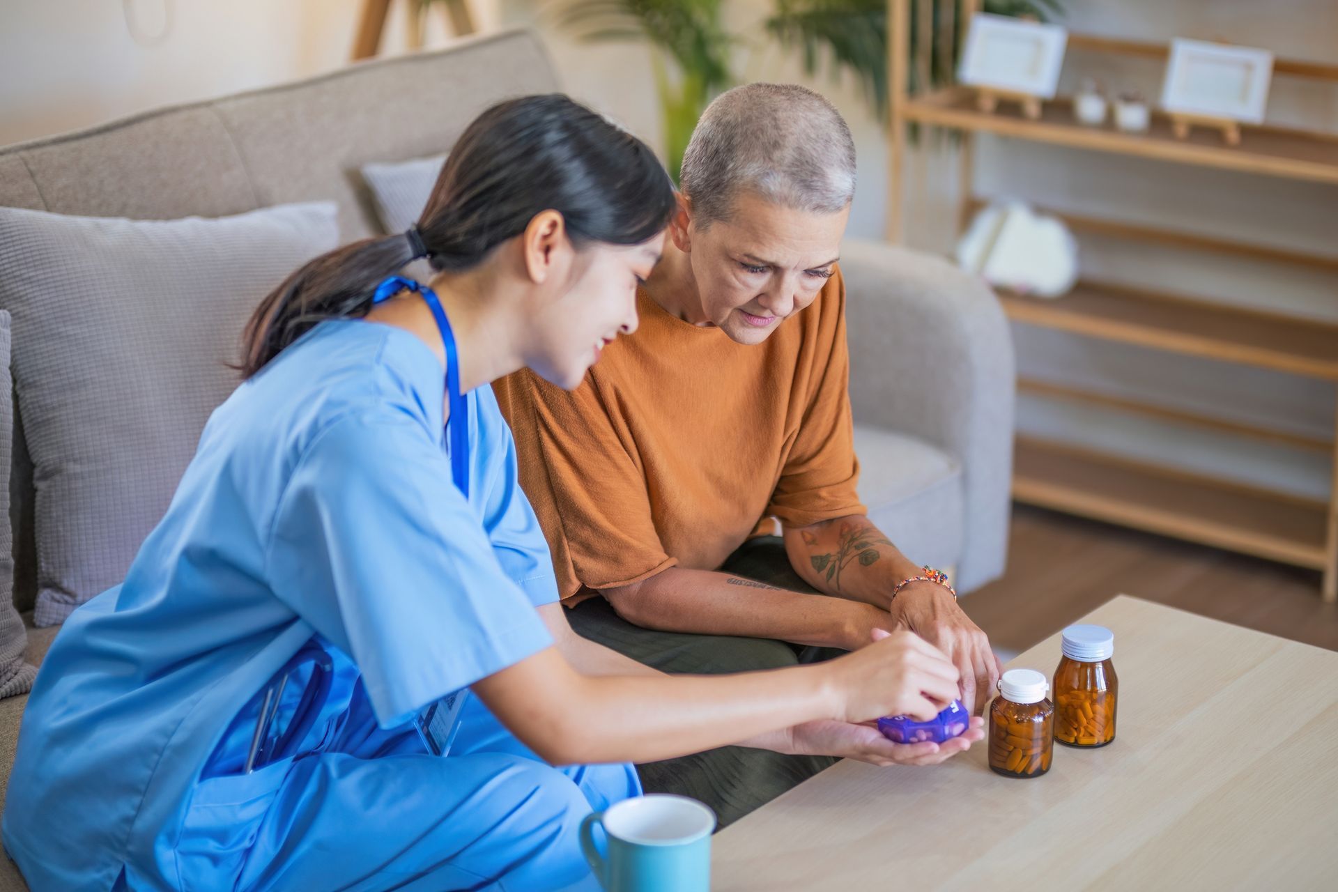 A nurse is helping an elderly woman with her medication.