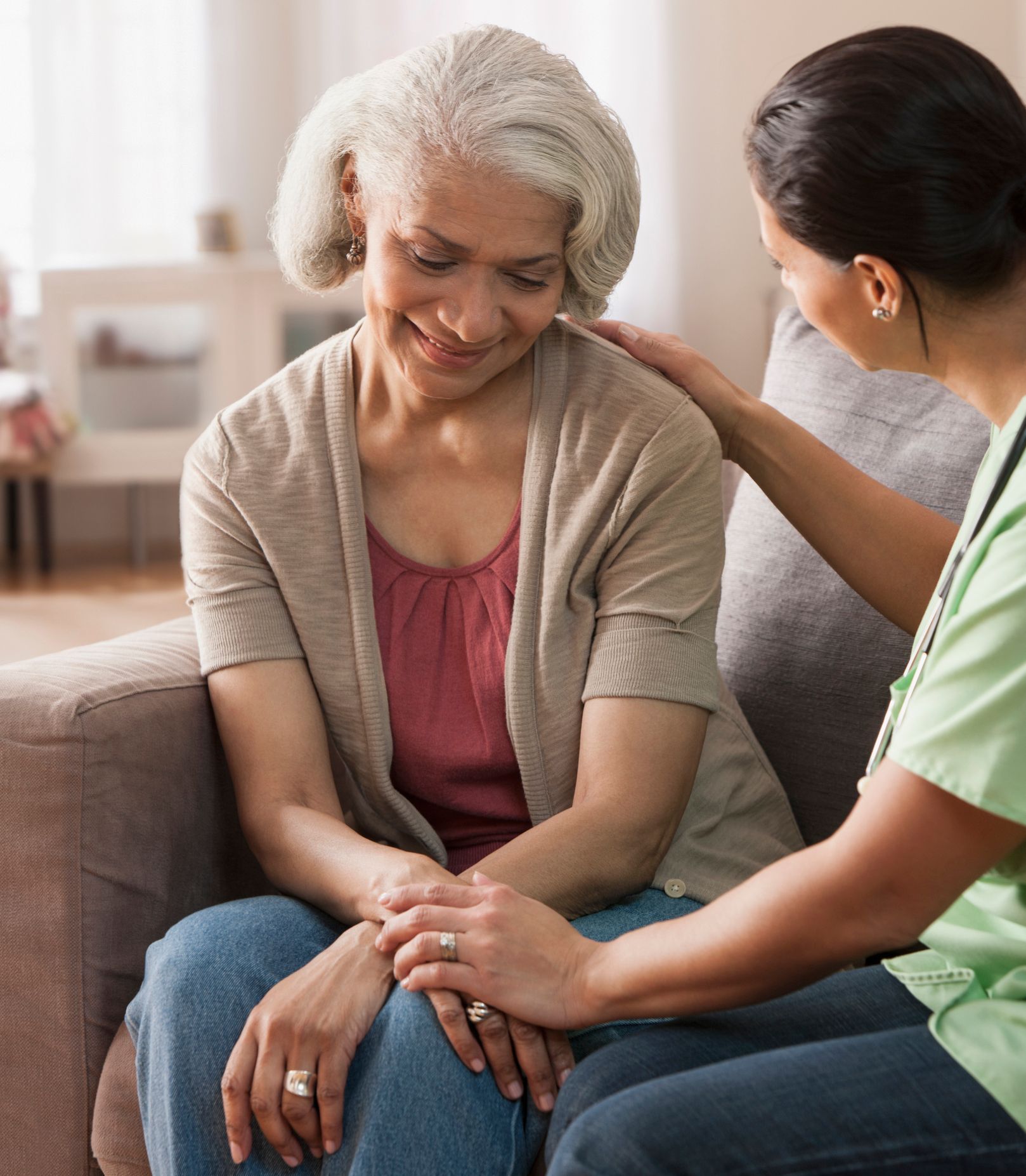 Two individuals seated comfortably on a sofa.