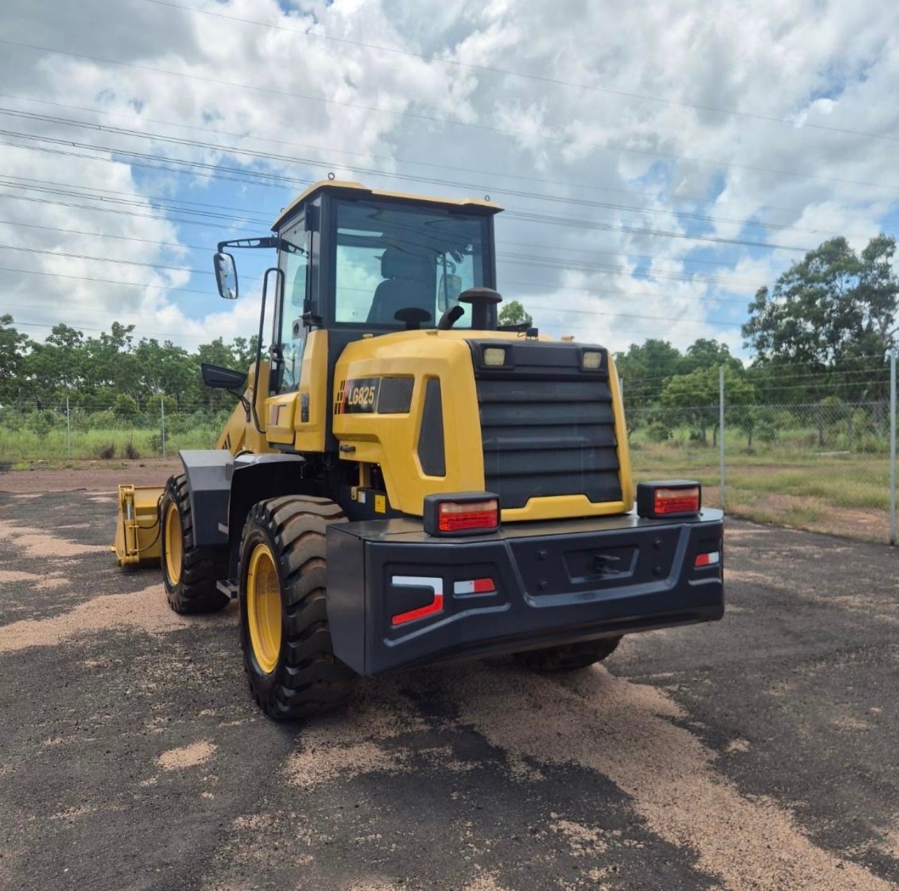A yellow farm machine is parked on a road with trees in the background— All things Diesel NT in Coolalinga, NT 