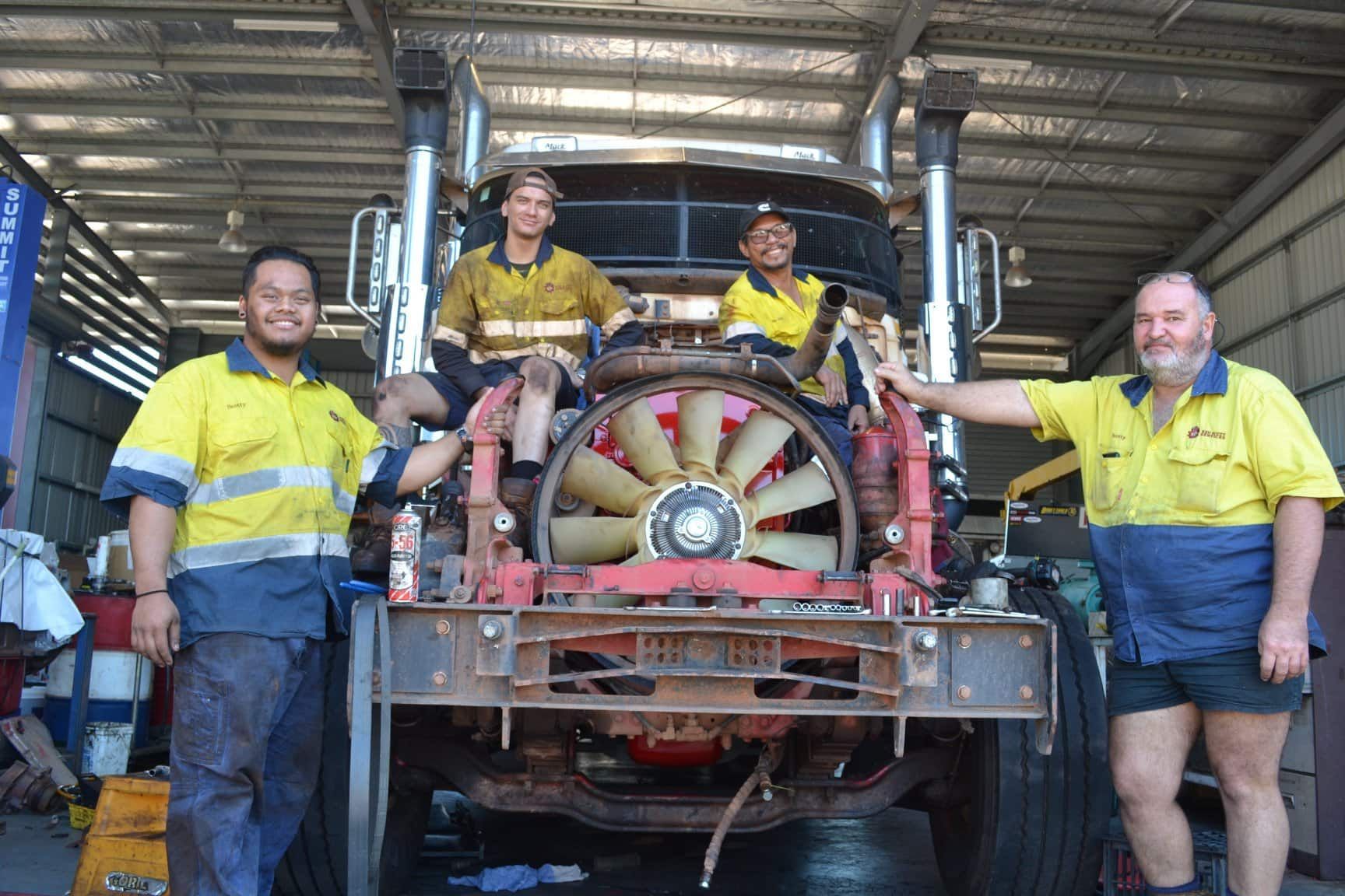 A Group of Men Are Standing in Front of a Truck in a Garage — All things Diesel NT in Tivendale, NT 
