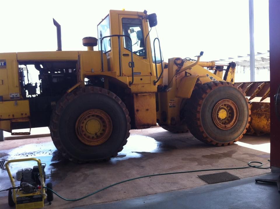 A Large Yellow Cat Tractor is Parked in a Garage — All things Diesel NT in Tivendale, NT 