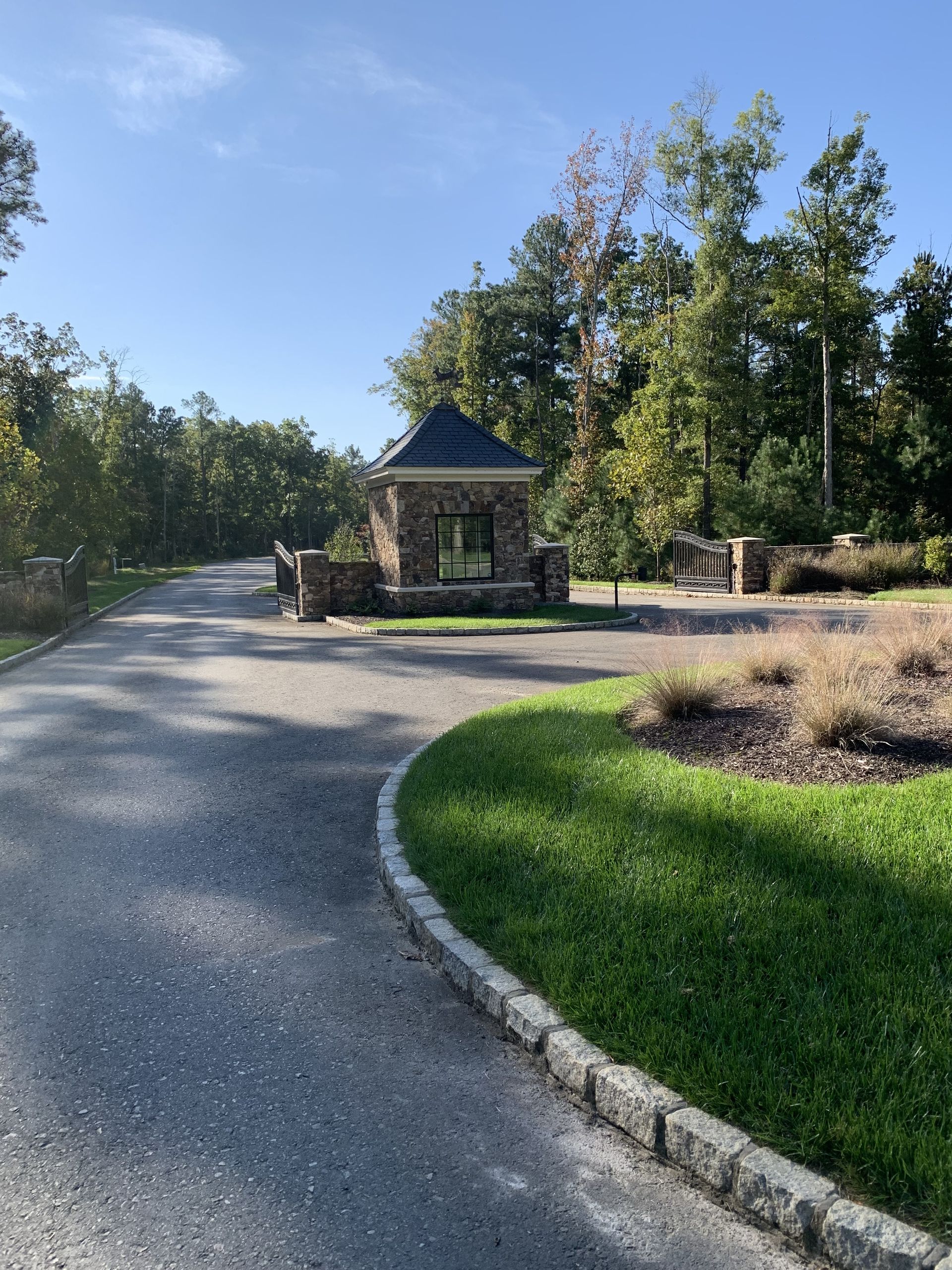 Stone gatehouse at driveway entrance.