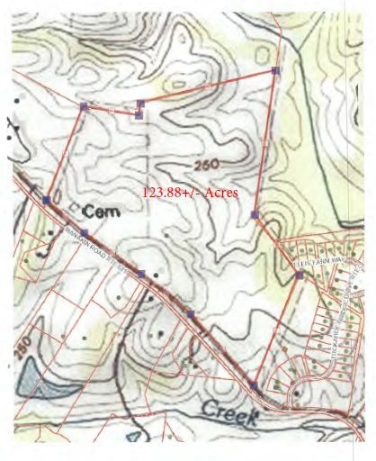Topographic map of a 23.88-acre property with boundary marked in red, beside a road and a creek.