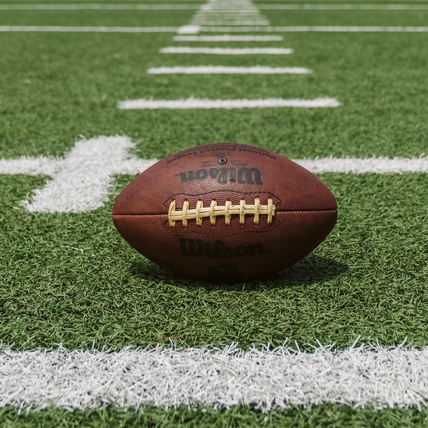close up image of a football on a football field