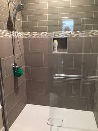 a shower with a glass door and a shower head .