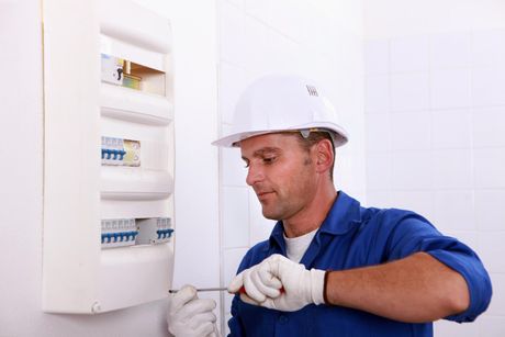 worker installing an electrical panel