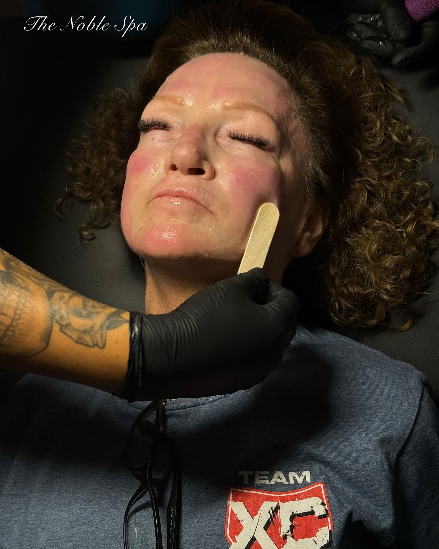 A woman is getting her legs waxed in a beauty salon.
