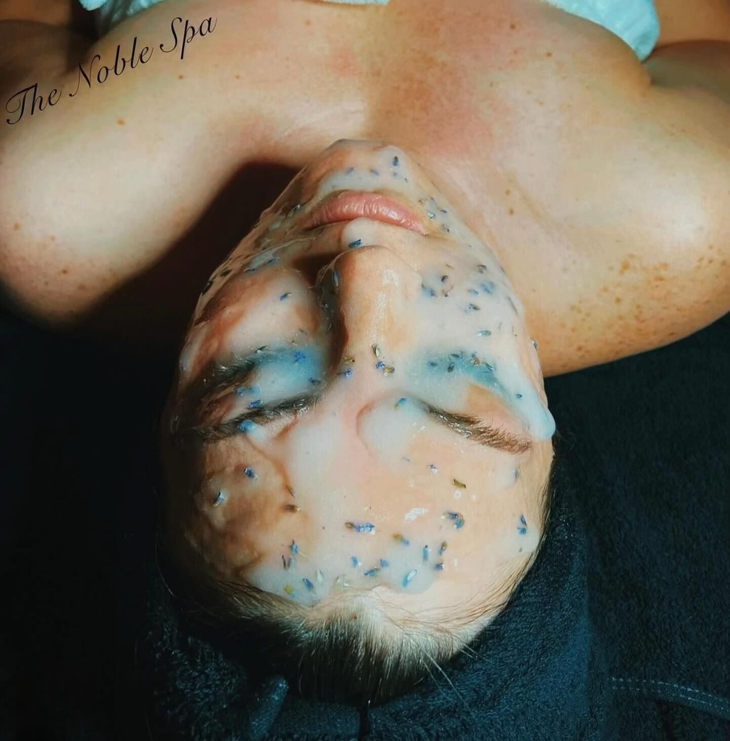 A woman with a noble spa tattoo on her shoulder