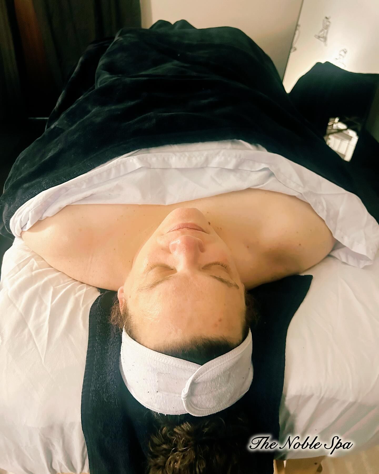 A woman is getting her eyebrows waxed in a beauty salon.