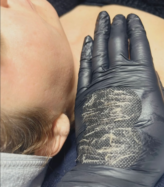 A close up of a person 's face with a black glove on